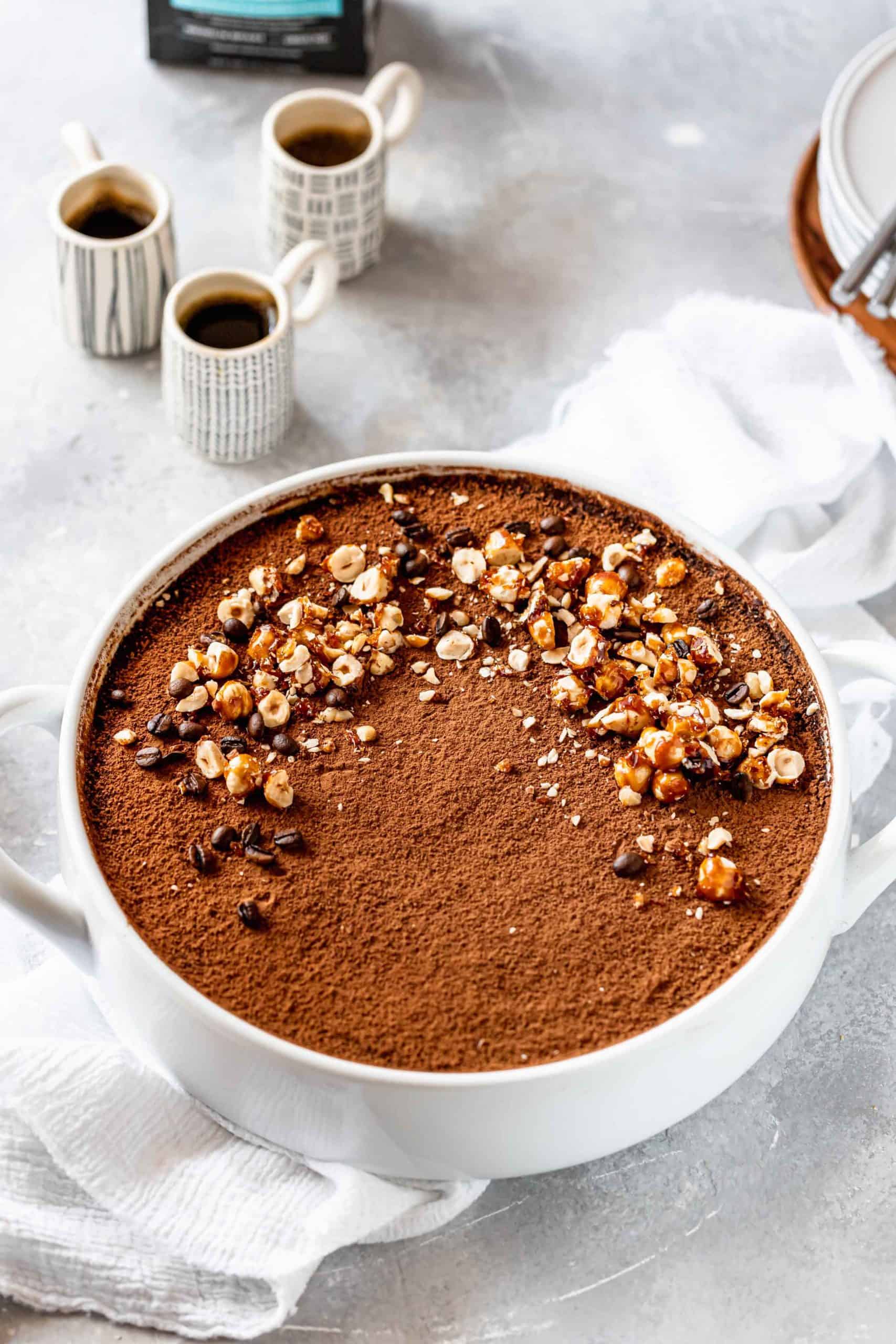 Hazelnut Tiramisu in baking dish with cups of espresso