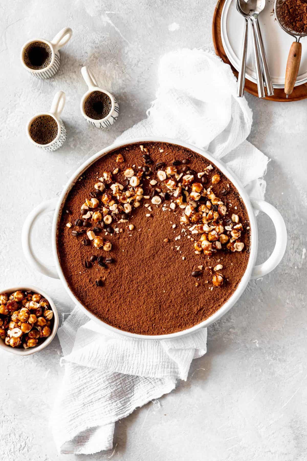 tiramisu in a baking dish with candied hazelnuts