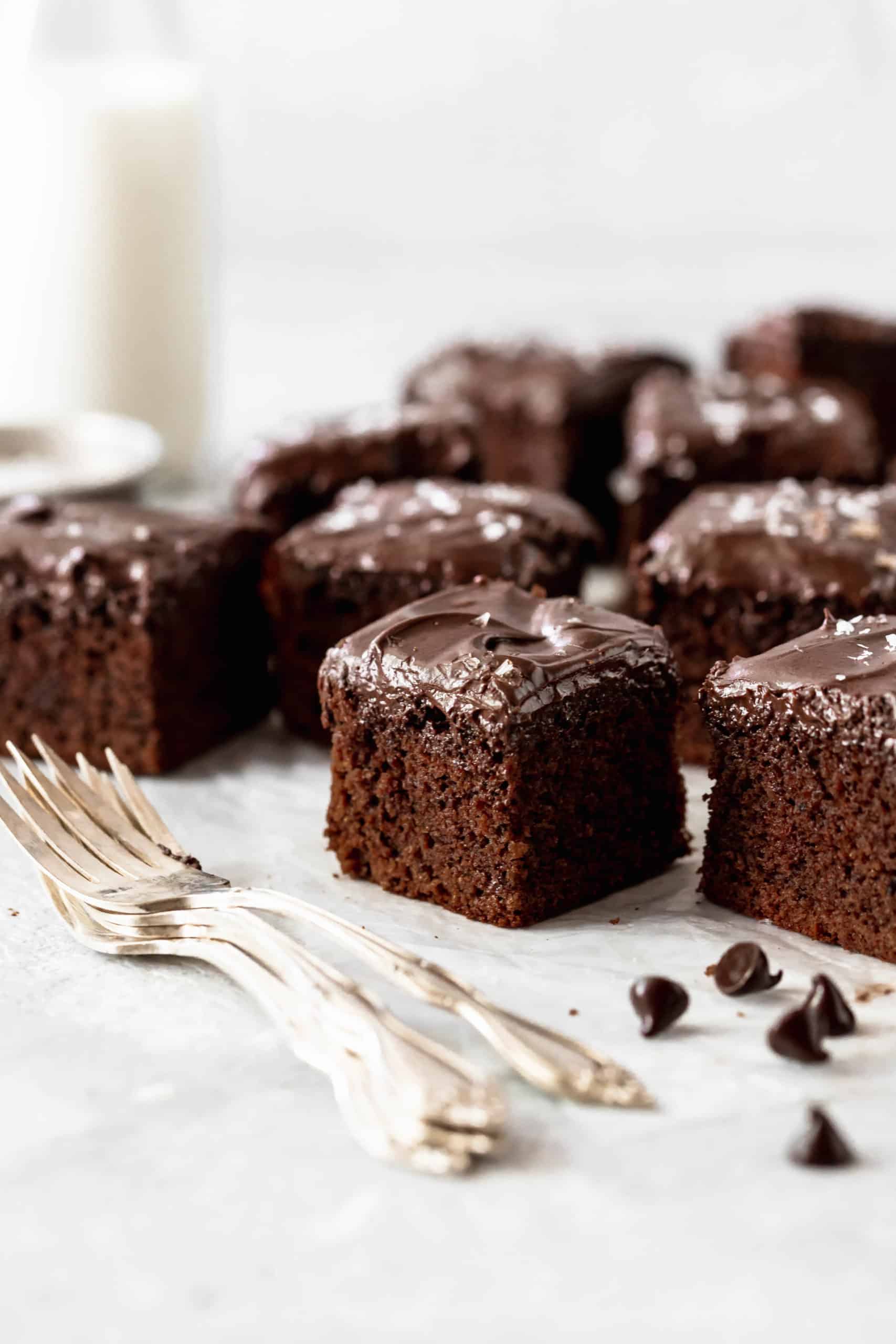 chocolate cake pieces with chocolate frosting on parchment paper