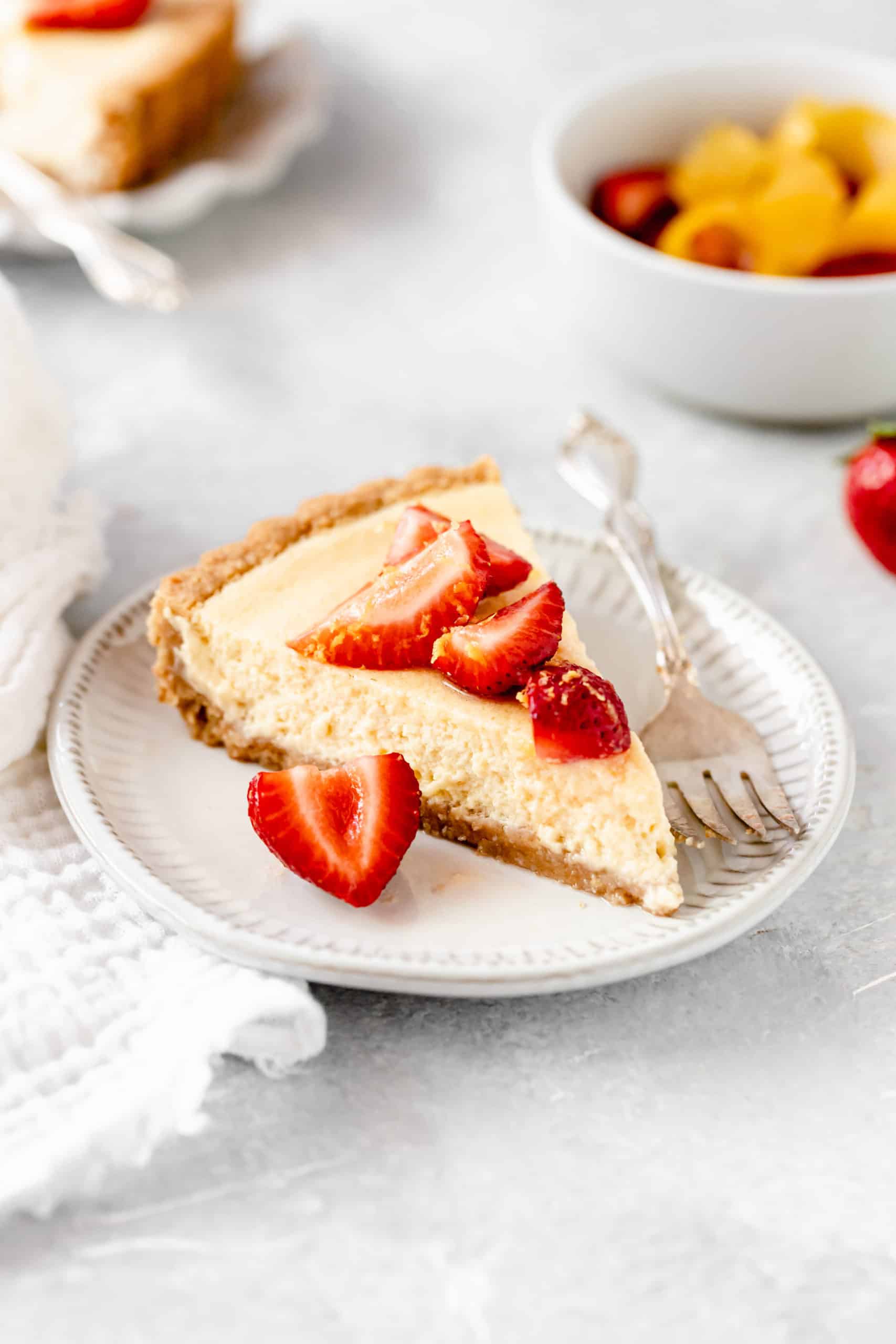 slice of lemon tart with strawberries slices on top