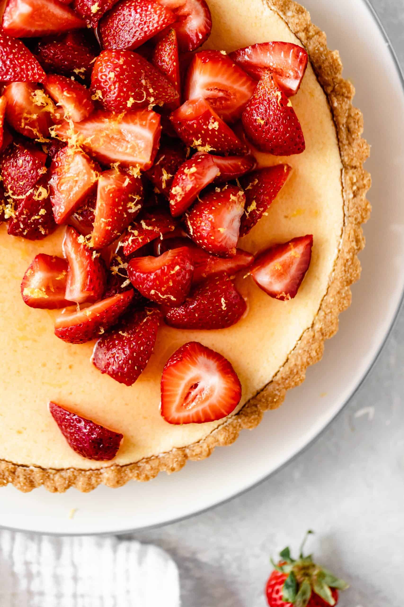 sliced strawberries on a lemon tart