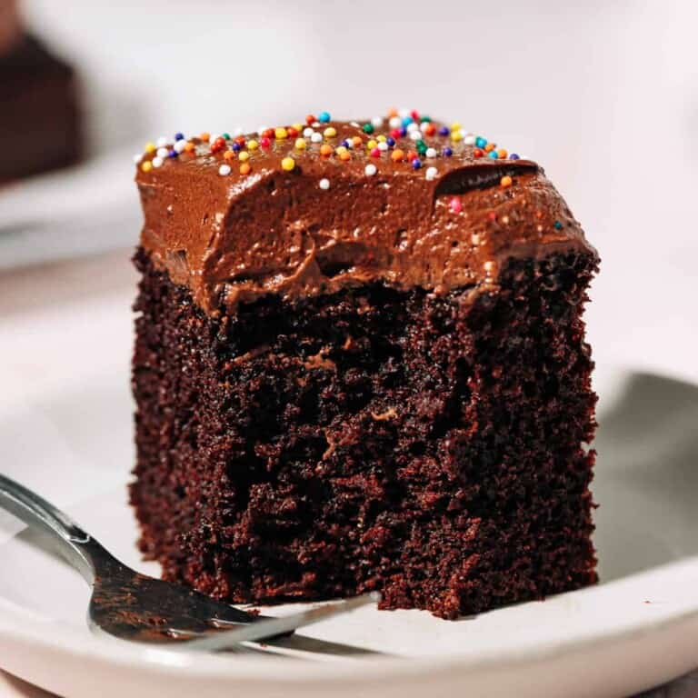 Slice of one layer chocolate with chocolate frosting on a plate.