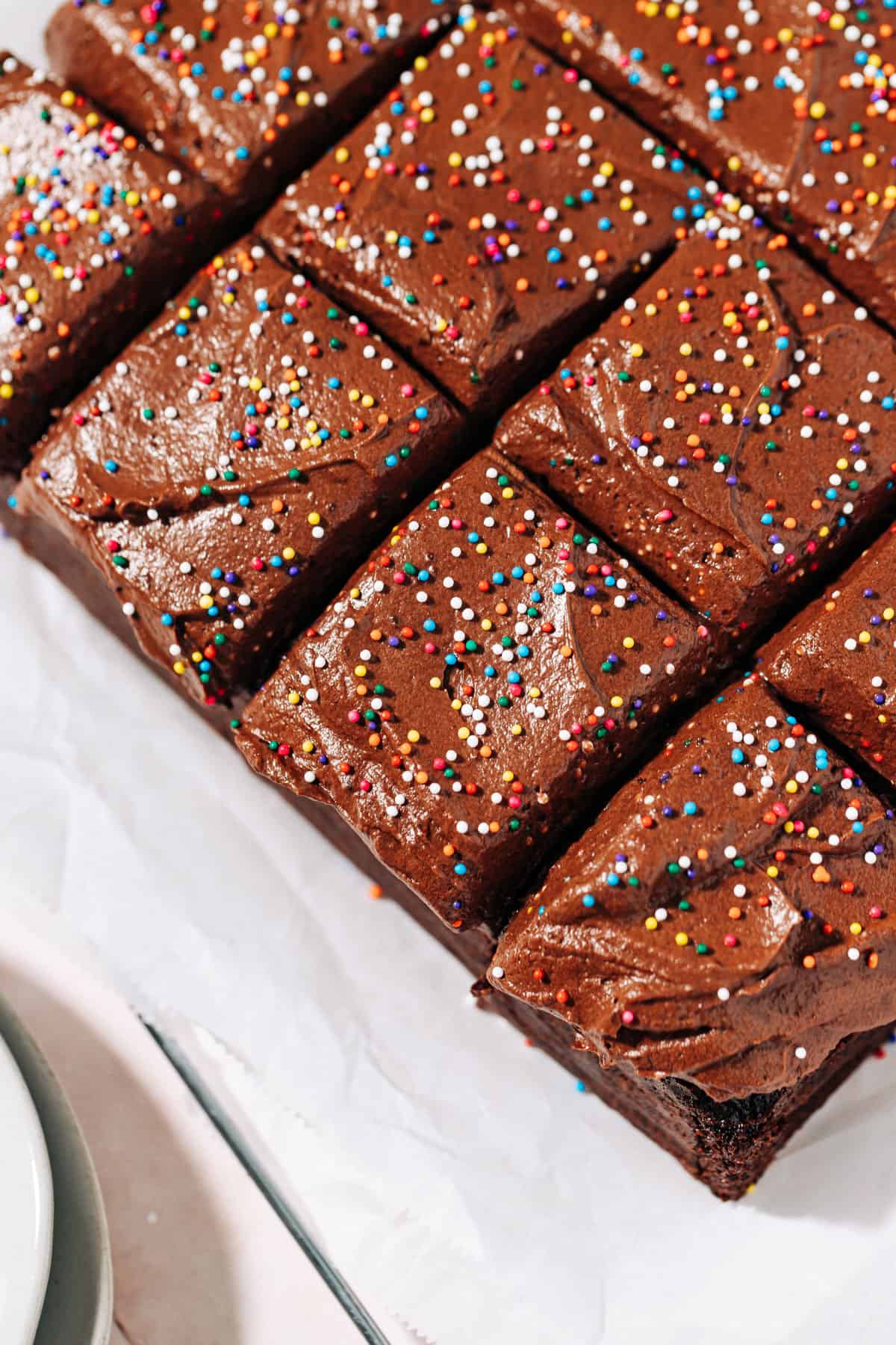 chocolate cake topped with chocolate frosting and sprinkles.