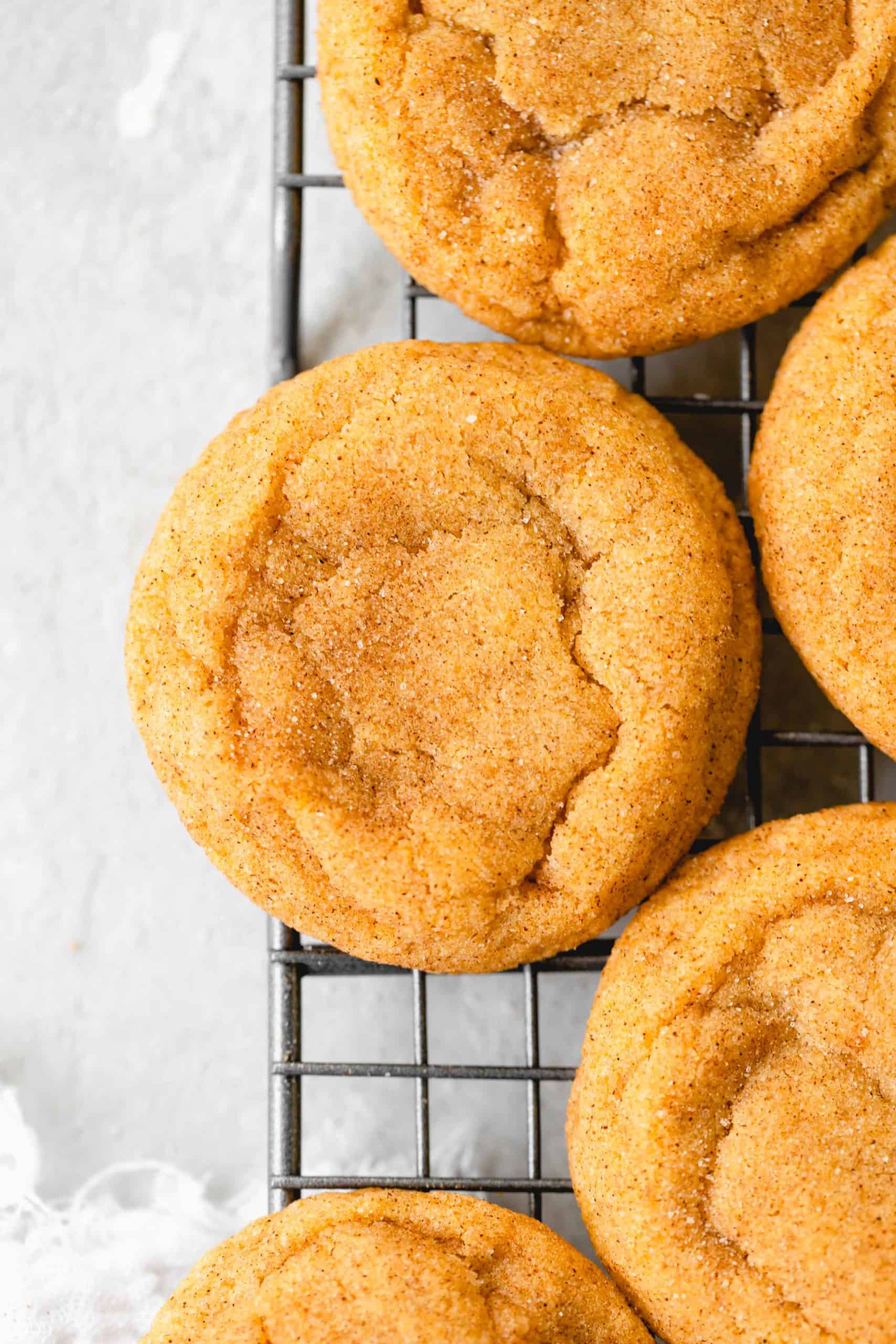 pumpkin snickerdoodle cookies on a wire rack