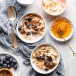 bulgur breakfast bowl topped with coconut flakes, blueberries, cinnamon, and honey
