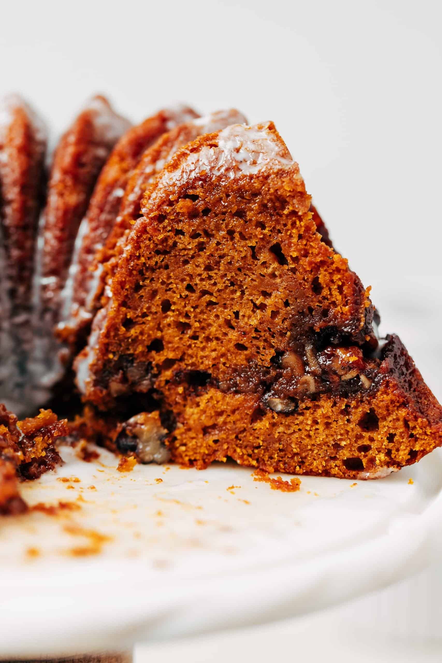 slice of of pumpkin bundt cake with streusel and glaze