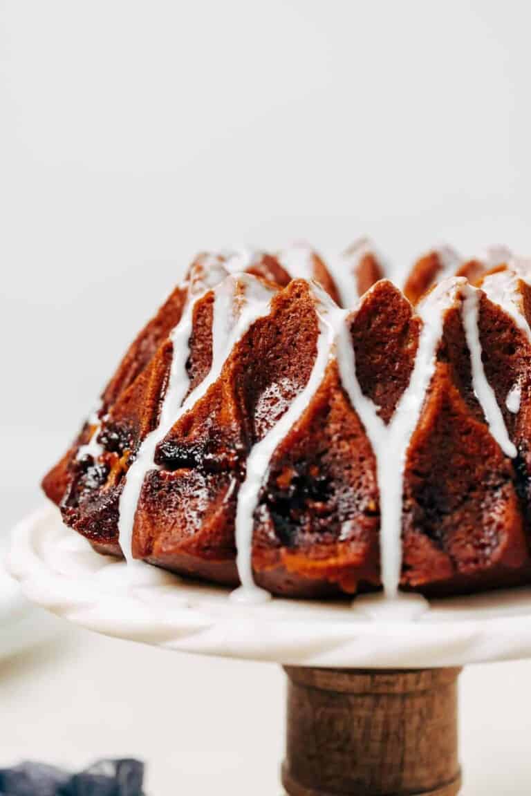 pumpkin bundt cake with glaze on a cake stand