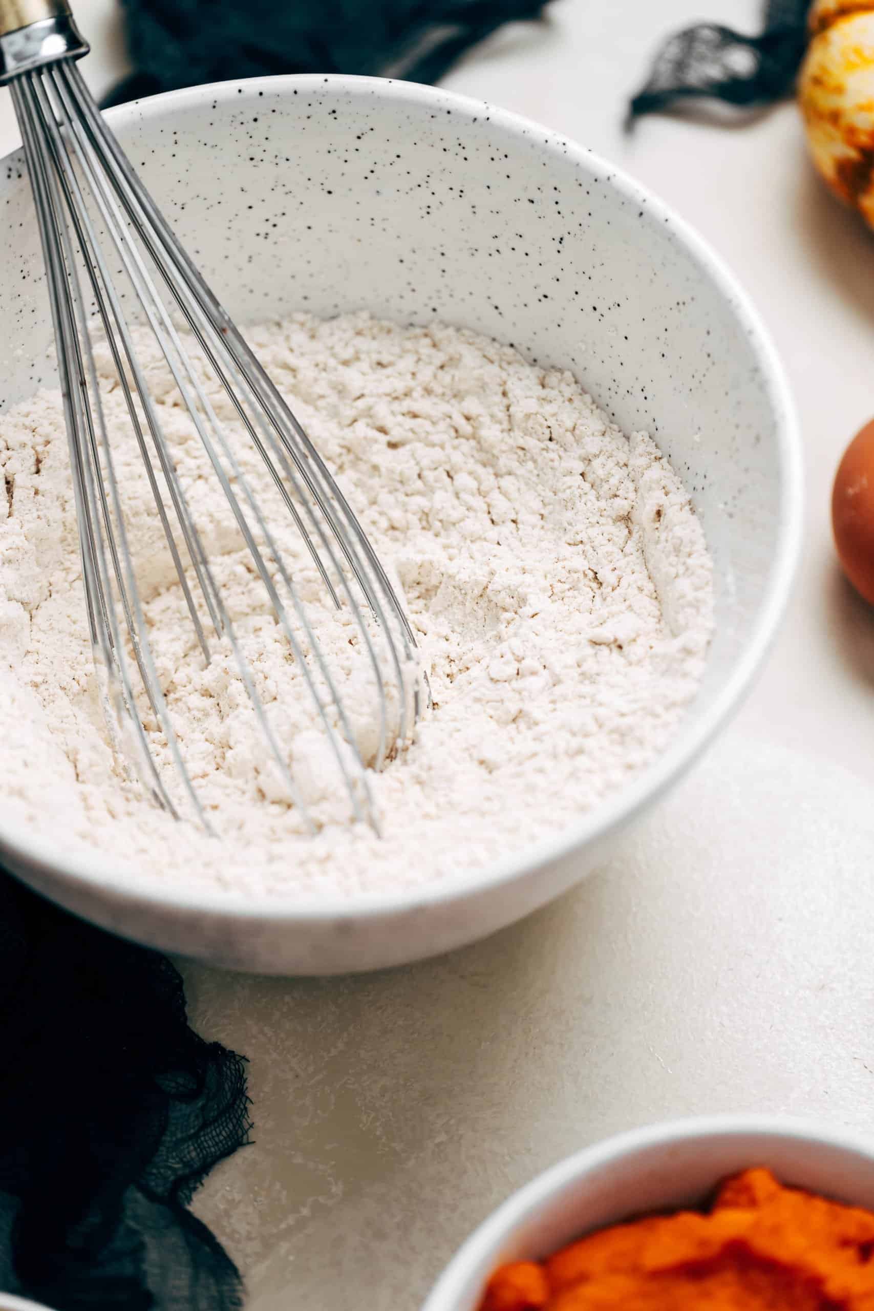 whisking flour in a mixing bowl