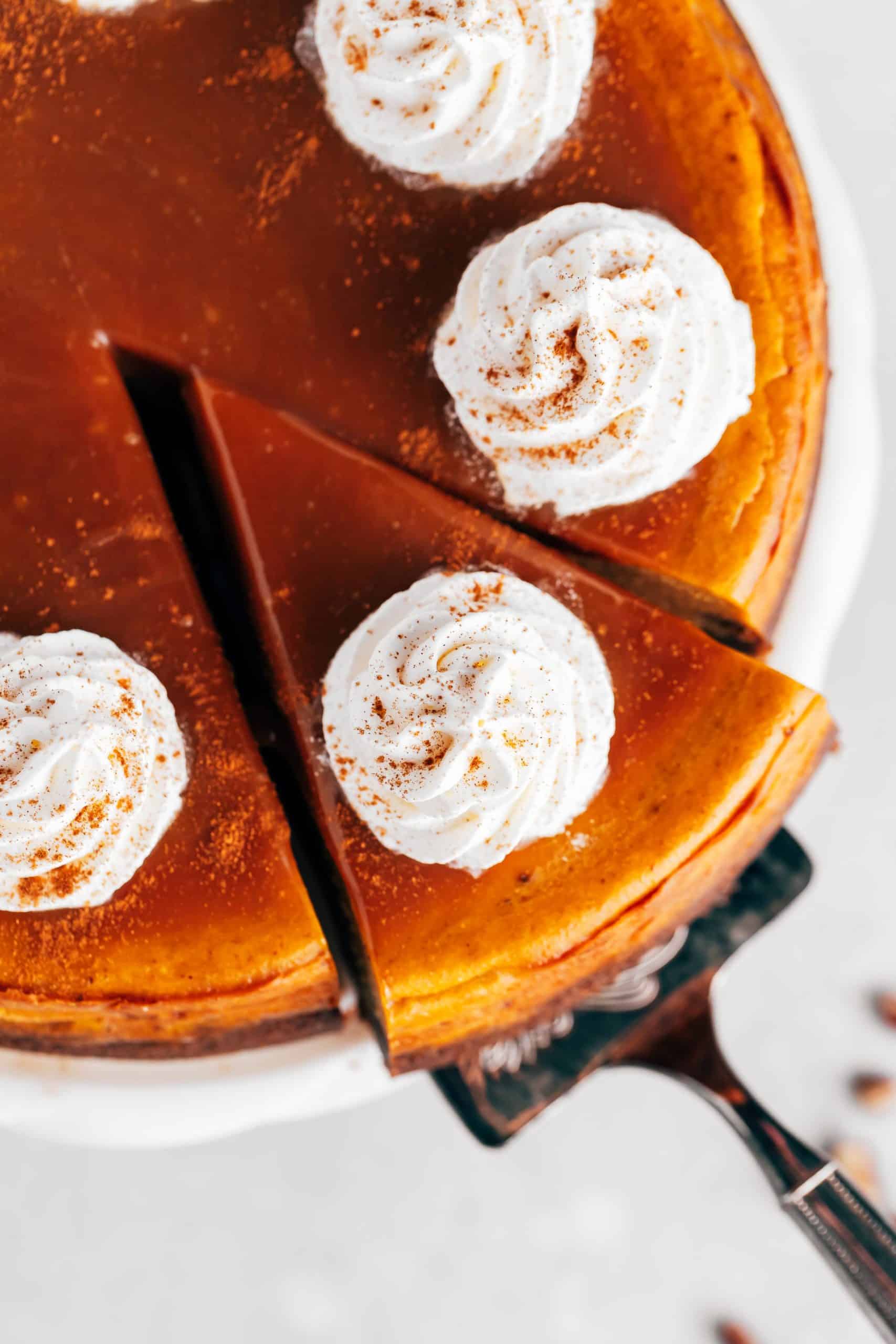 pumpkin cheesecake with caramel sauce and whipped cream