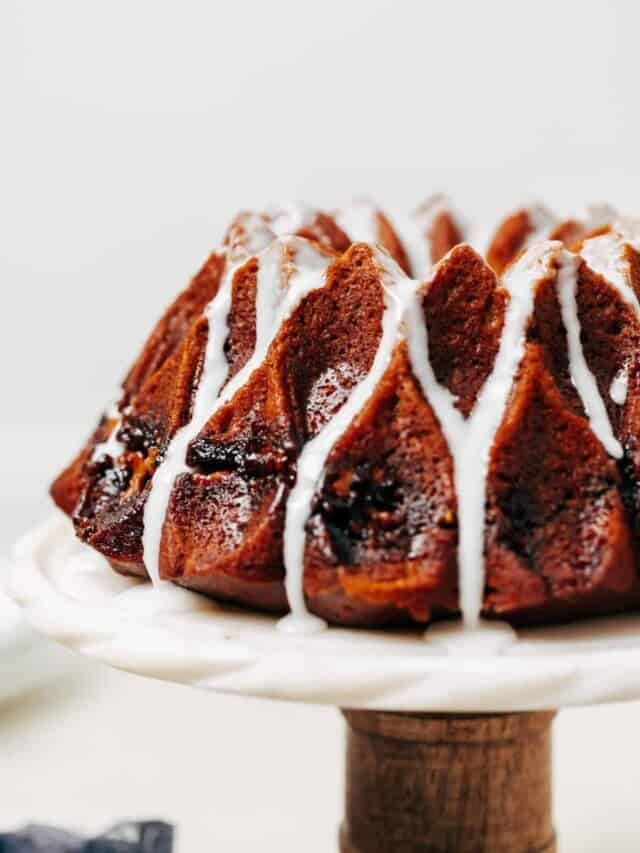 pumpkin bundt cake with glaze on a cake stand