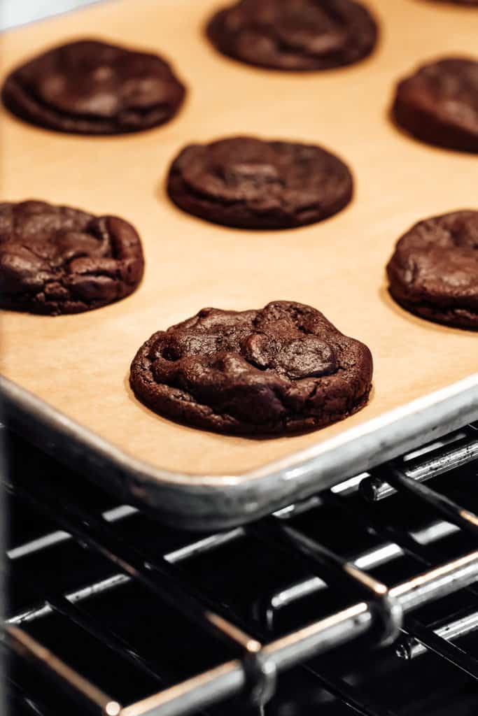 peppermint mocha cookies on a baking sheet in the oven