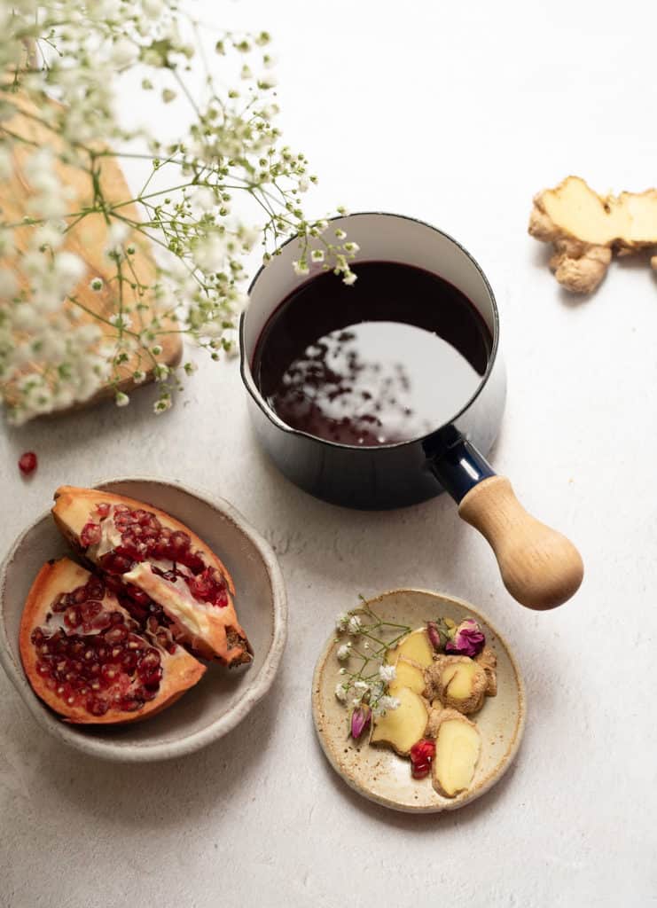 Pomegranate ginger syrup in a saucepan