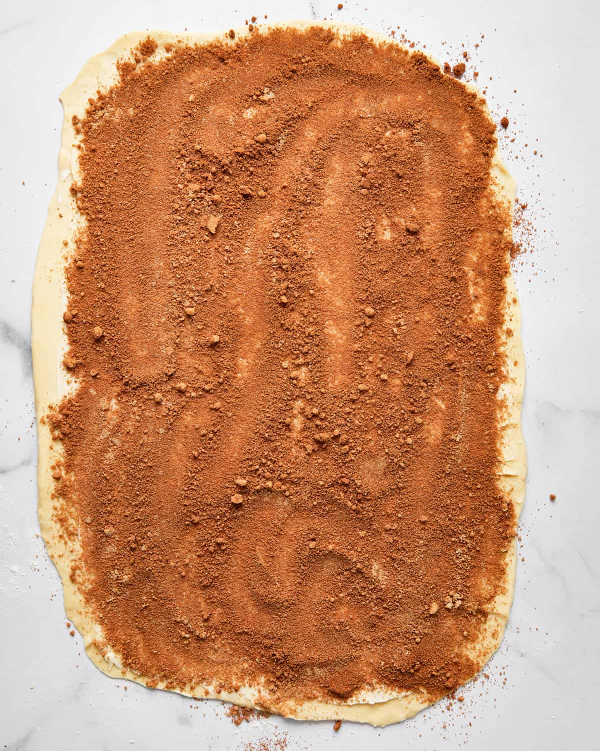 cinnamon sugar mixture spread over dough.