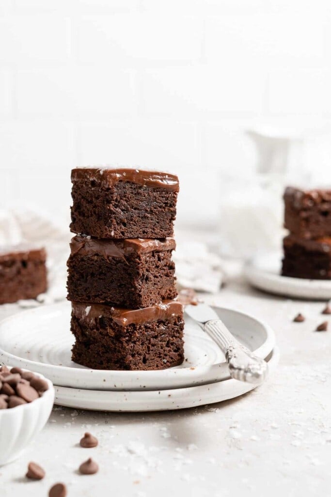 stack of fudgy brownies with ganache