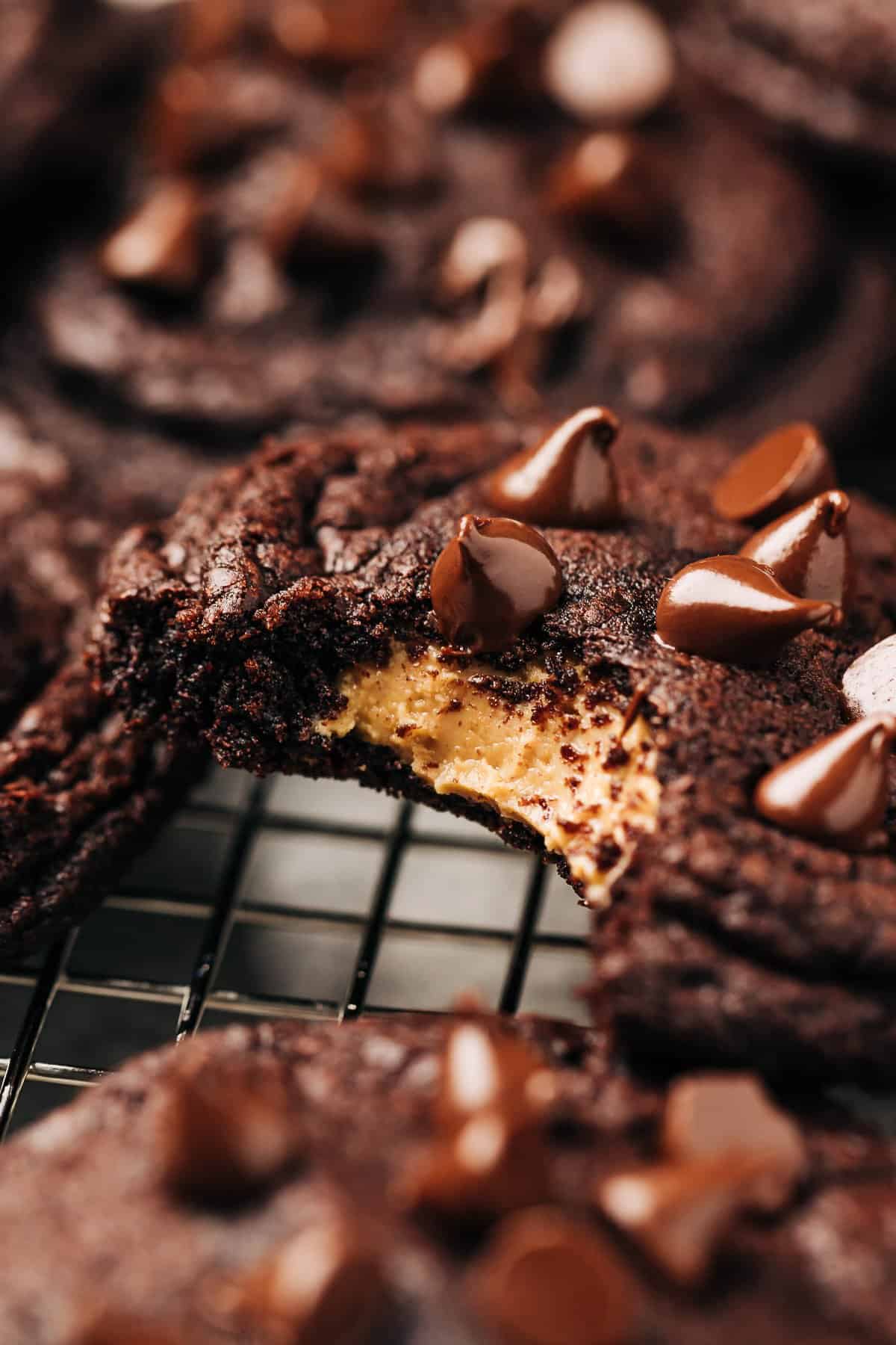 peanut butter stuffed chocolate cookies on a wire rack