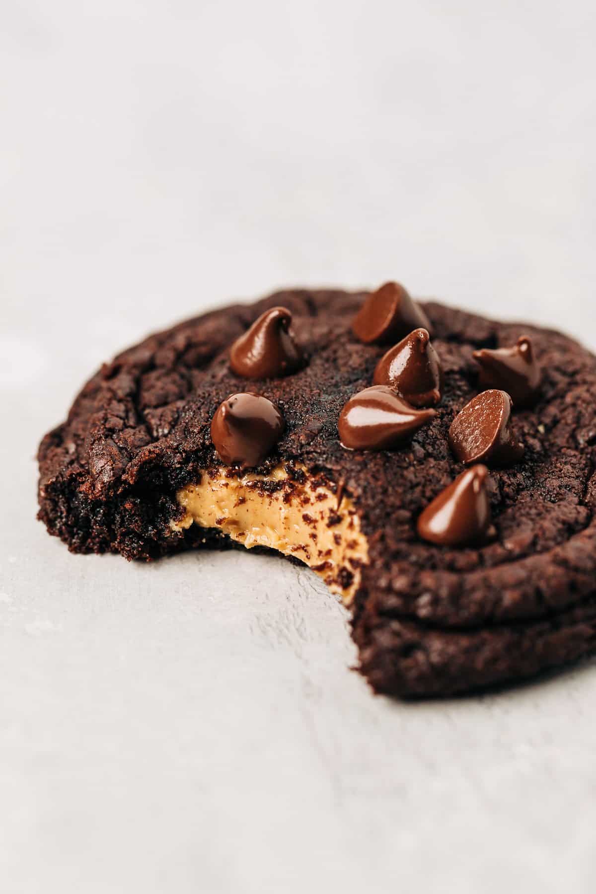 bite shot of a peanut butter stuffed chocolate cookie