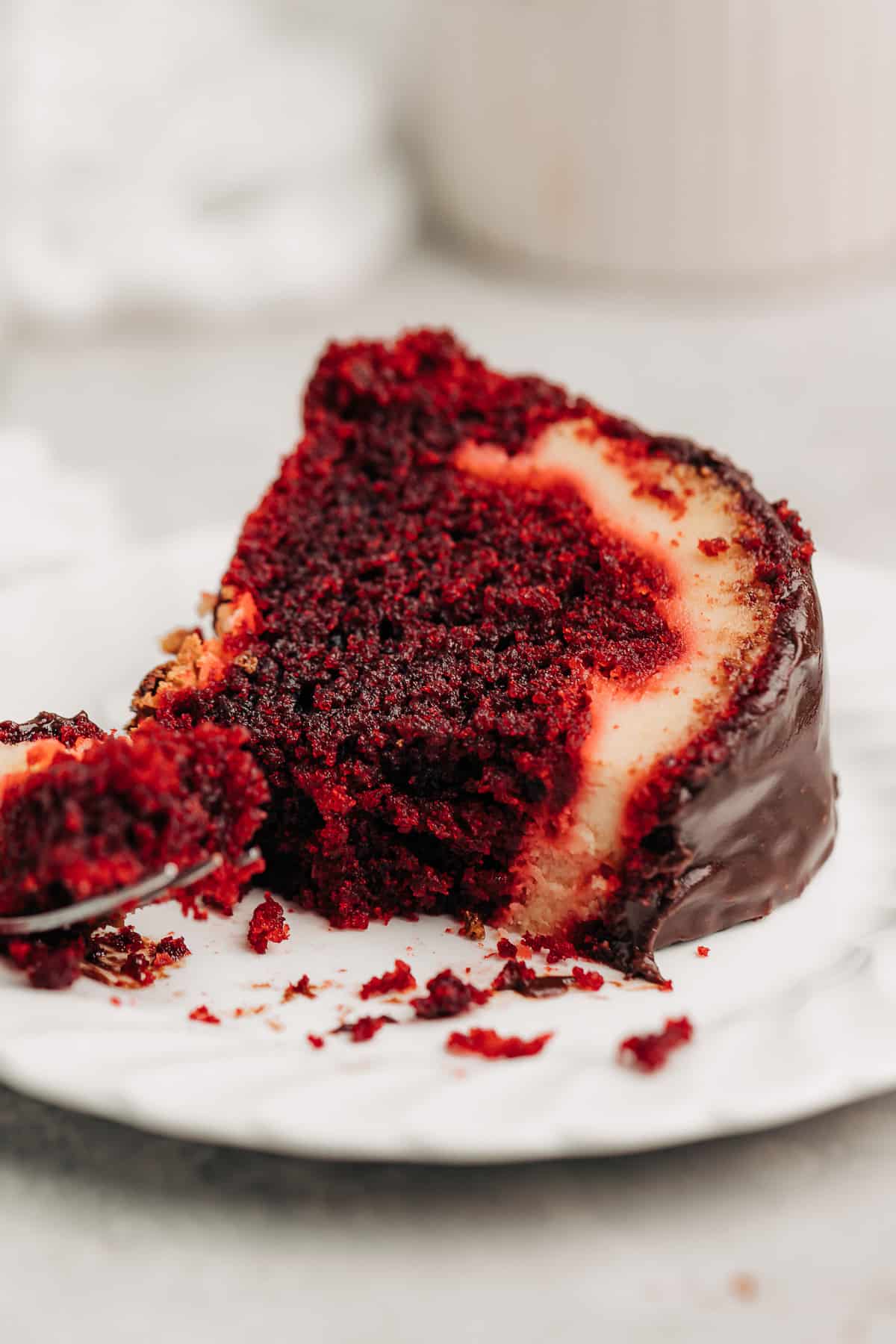 a slice of Red Velvet Cream Cheese Bundt Cake on a plate.