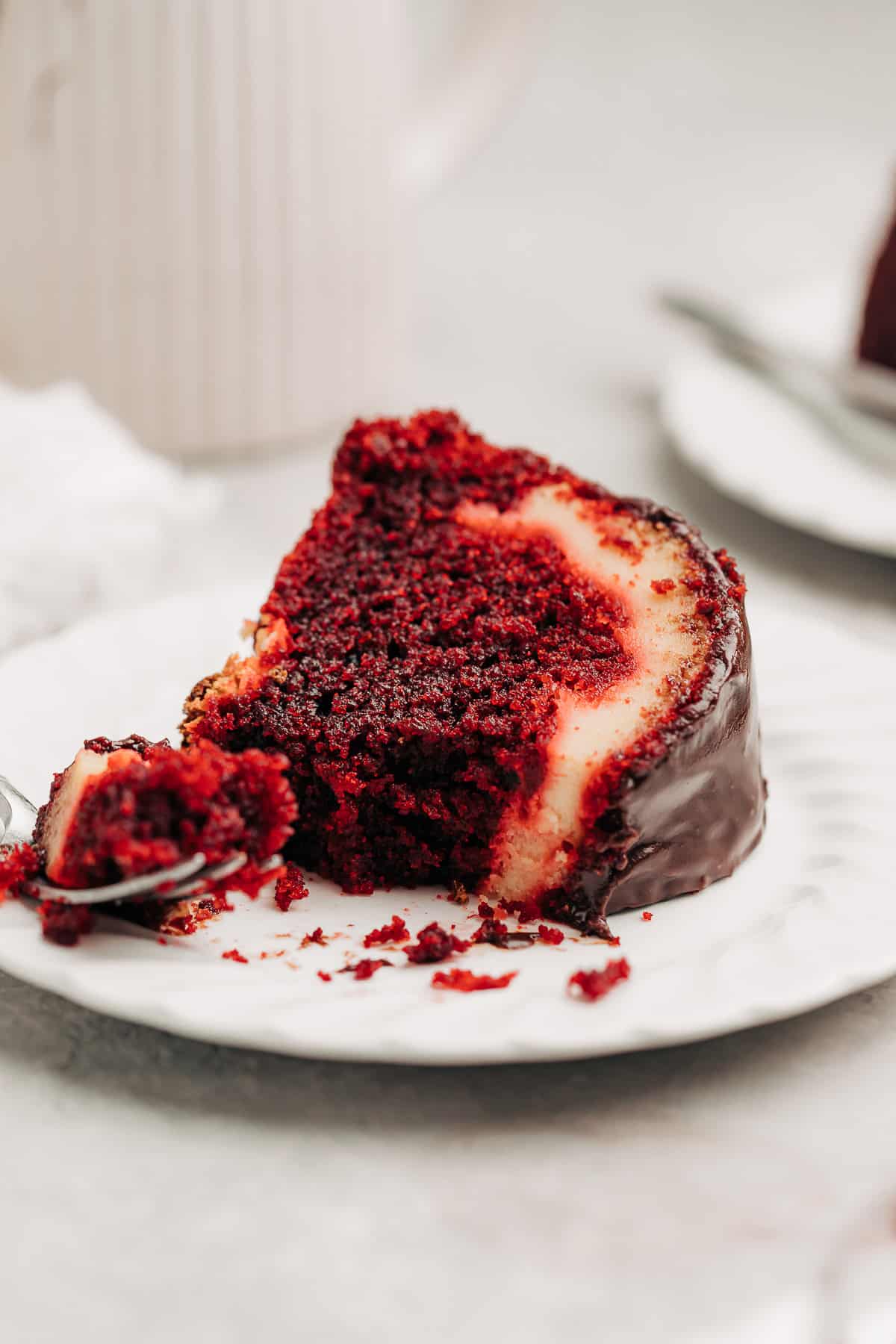 a slice of Red Velvet Cream Cheese Bundt Cake on a plate.