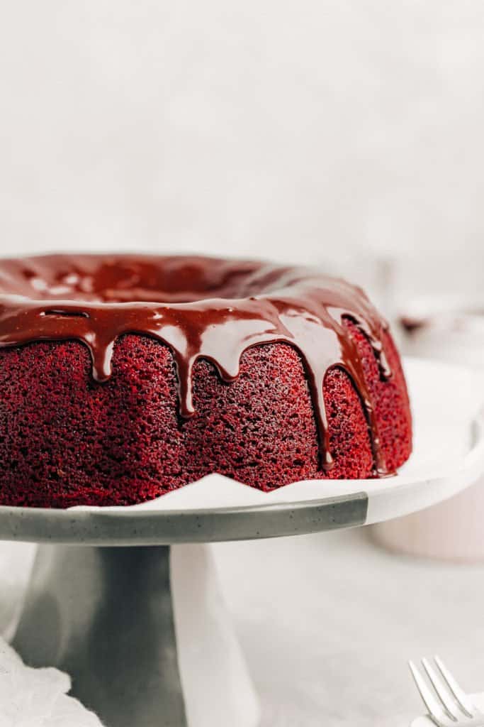 Red Velvet Bundt Cake with nutella glaze on a cake stand
