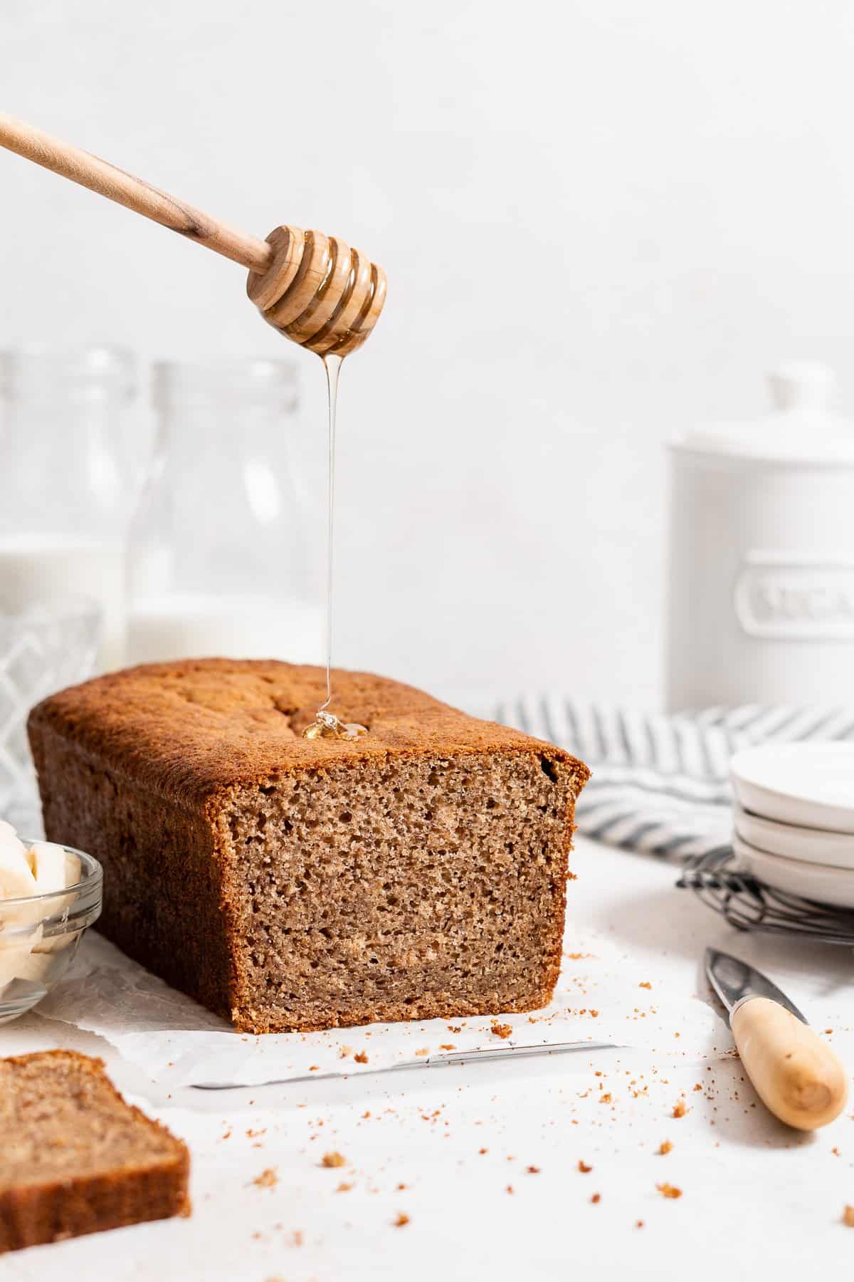 loaf of whole wheat banana bread with a honey drizzle.