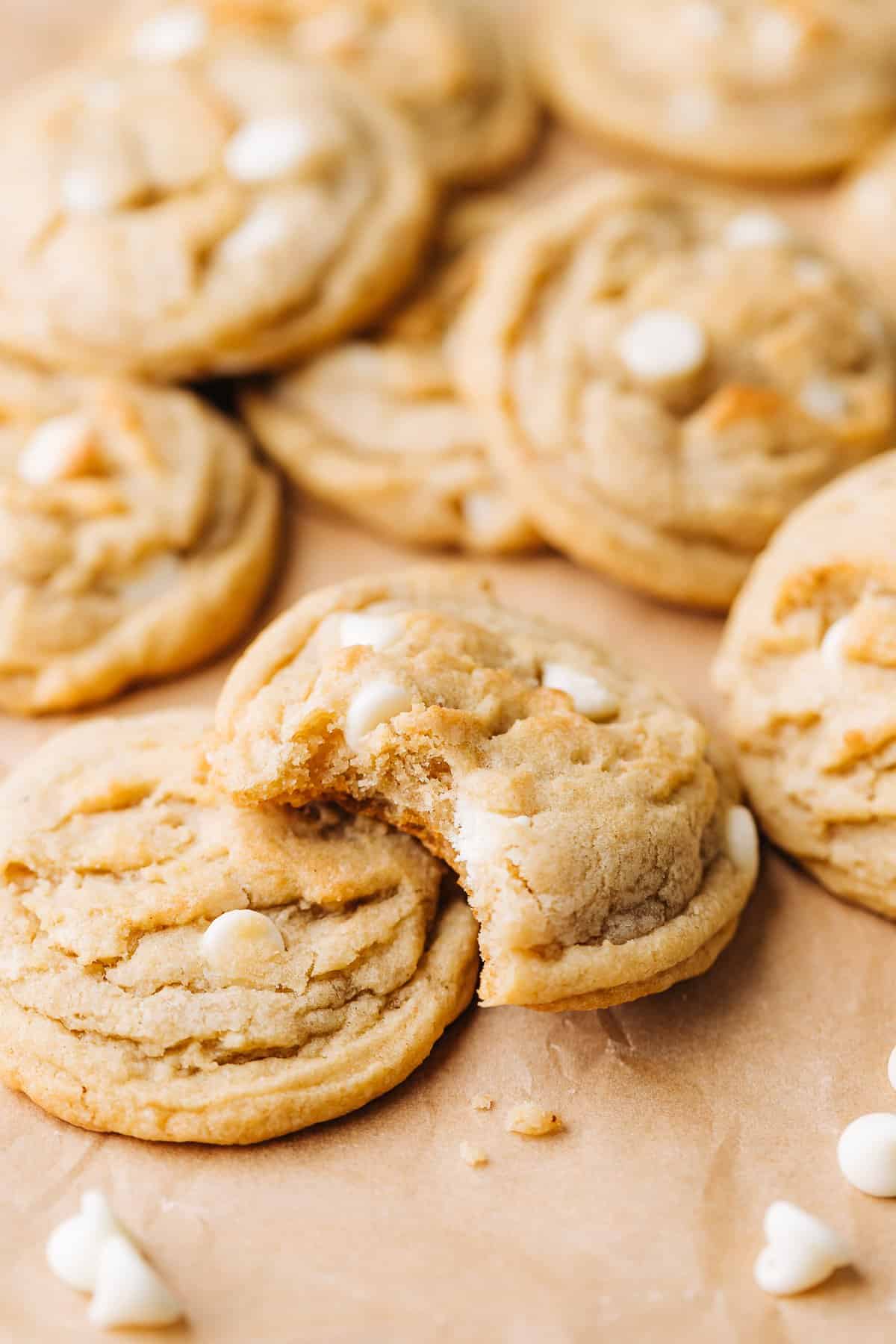 banana white chocolate chip cookies on brown parchment paper.