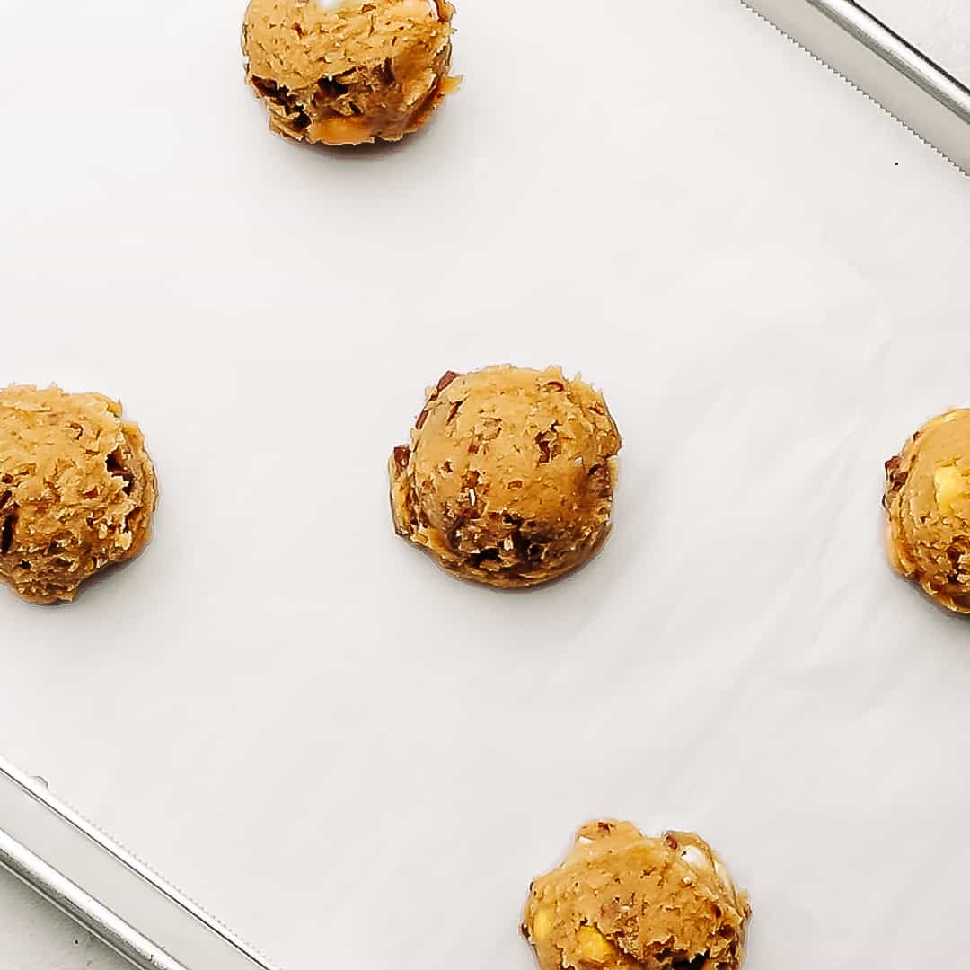 unbaked cadbury egg cookies on a baking sheet.