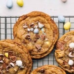 Cadbury Mini Egg chocolate chip cookies on a wire rack.