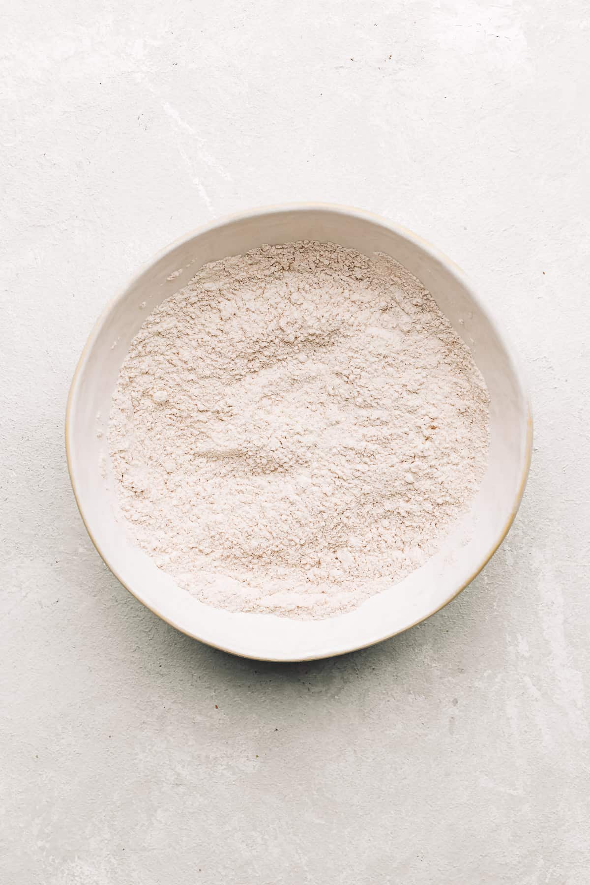 dry ingredients for carrot cake donuts in a bowl.