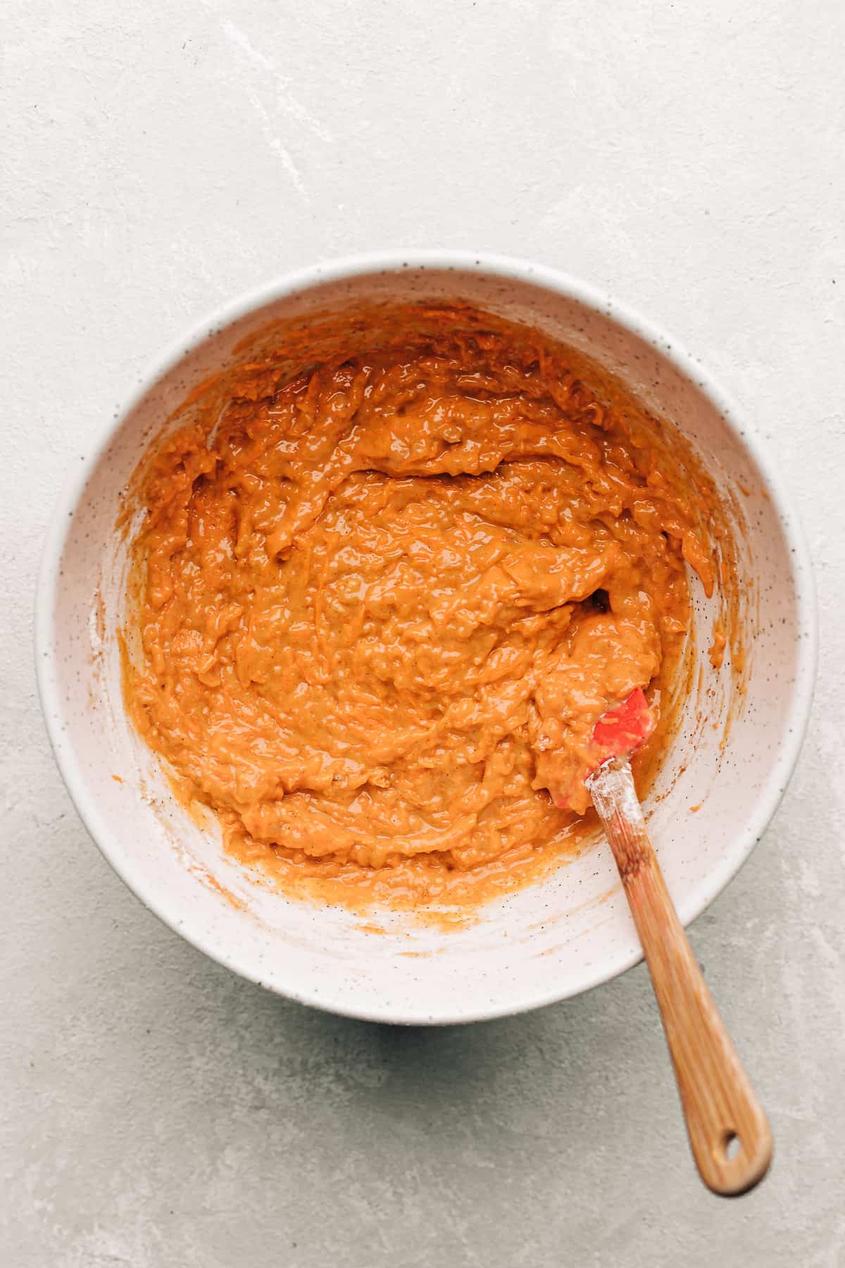 carrot cake donut batter in a mixing bowl.