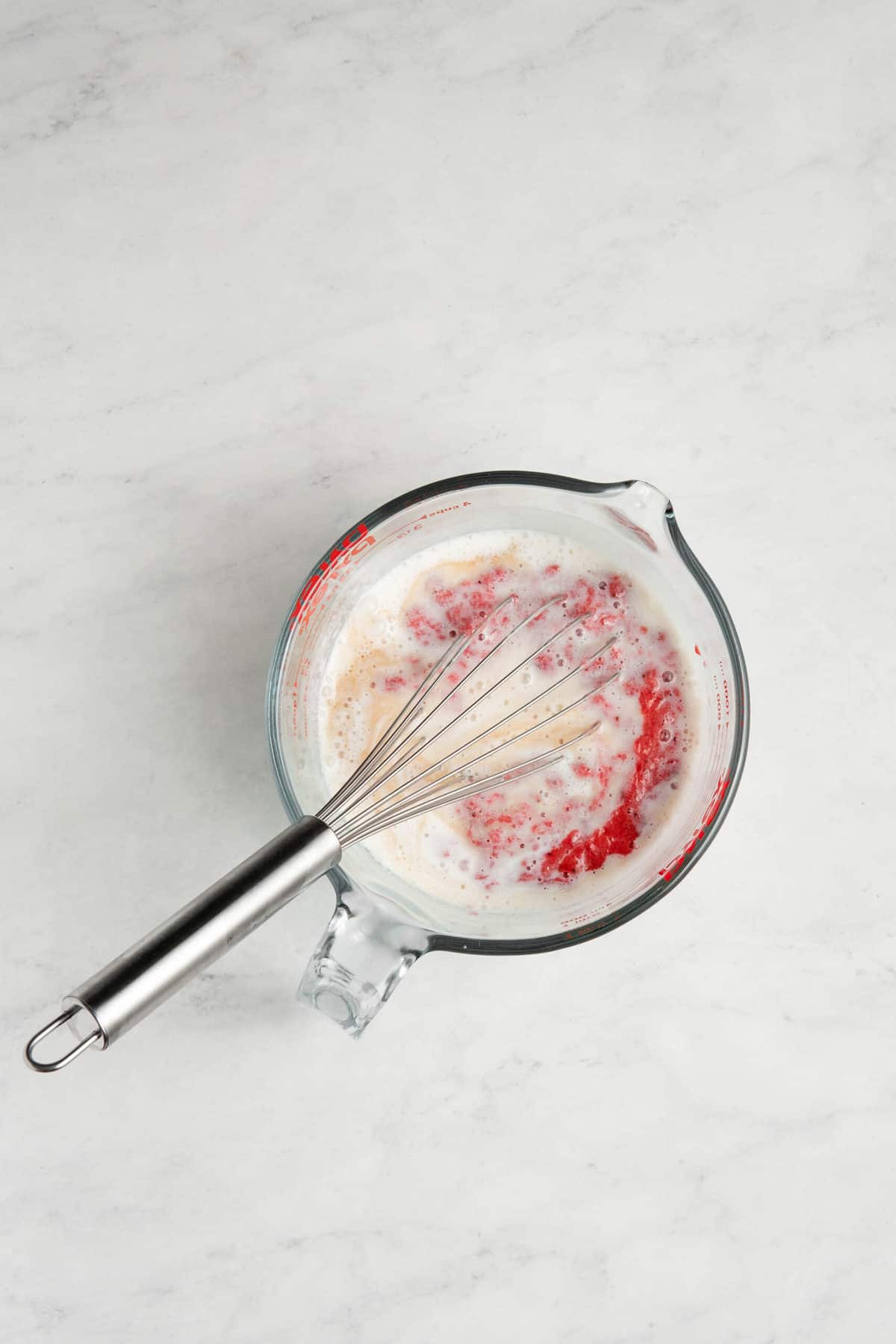 strawberry puree, egg whites, and buttermilk in a glass measuring cup.