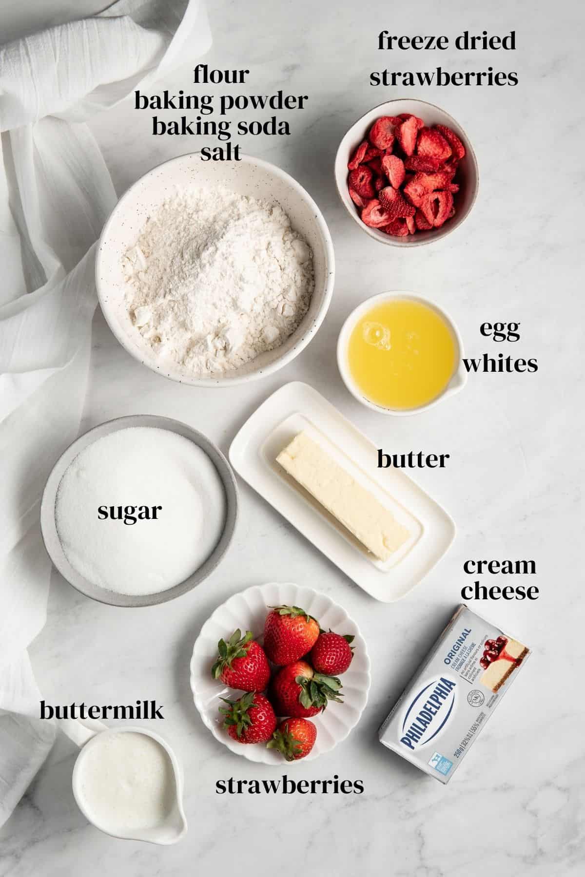 Flour, freeze dried strawberries, egg whites, butter, sugar, strawberries,  cream cheese, buttermilk in bowls.