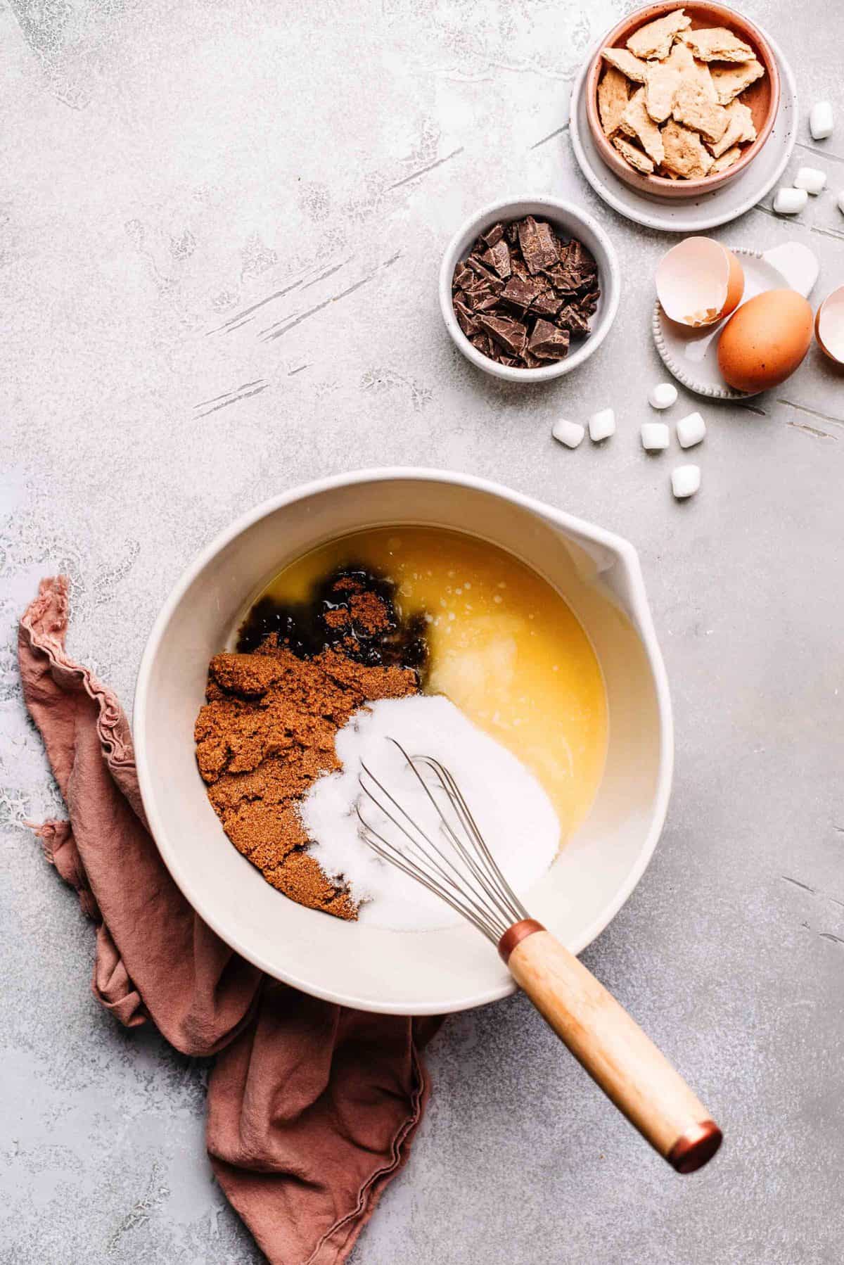 Melted butter, brown sugar, and sugar in a mixing bowl.