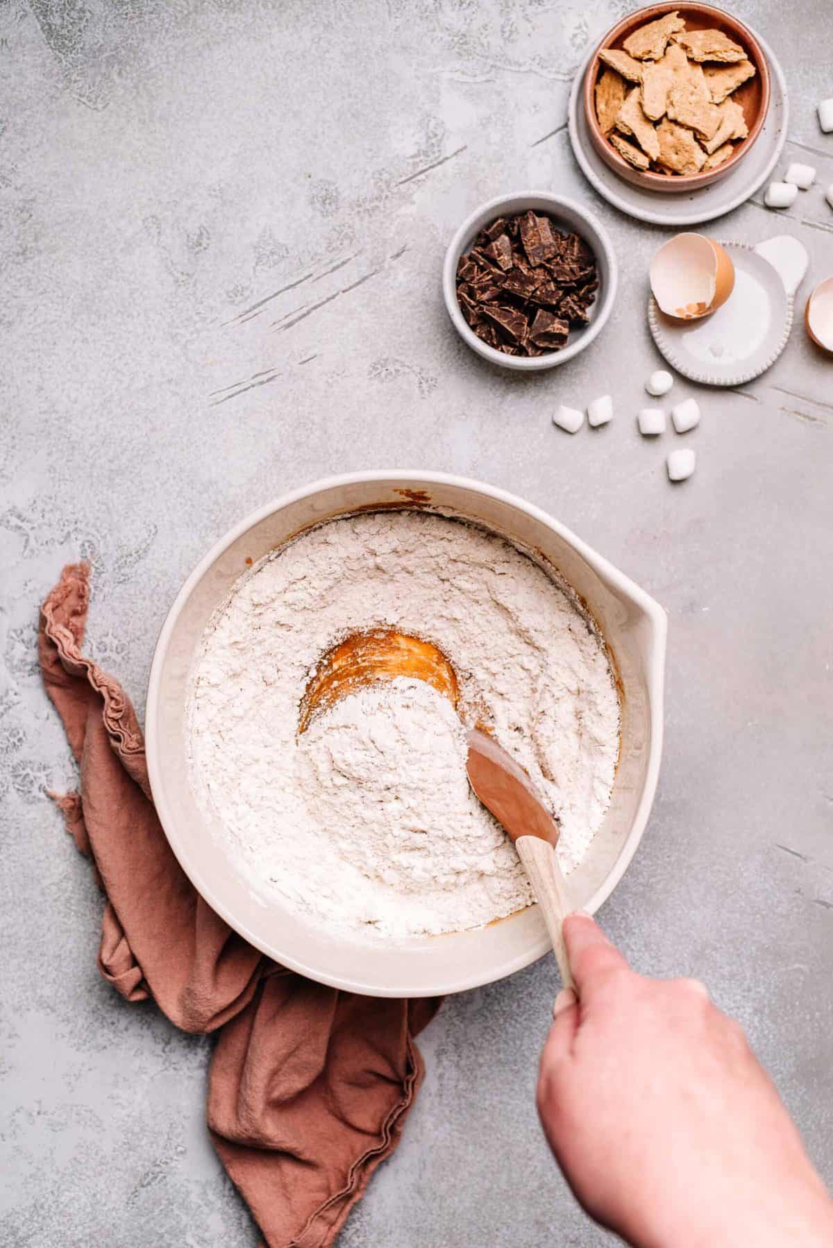 Mixing bowl with melted butter and sugar mixture and flour.