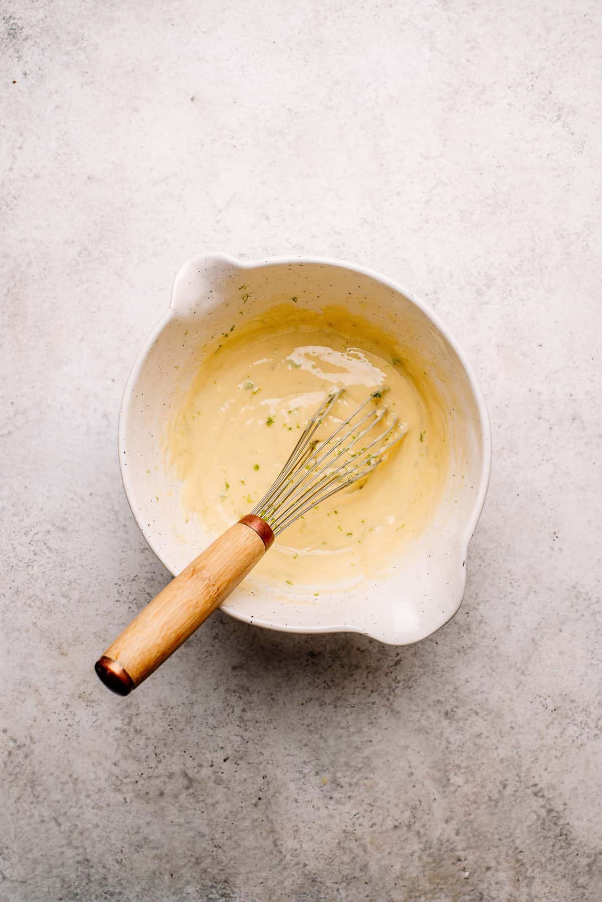 Key lime pie batter in a white mixing bowl.
