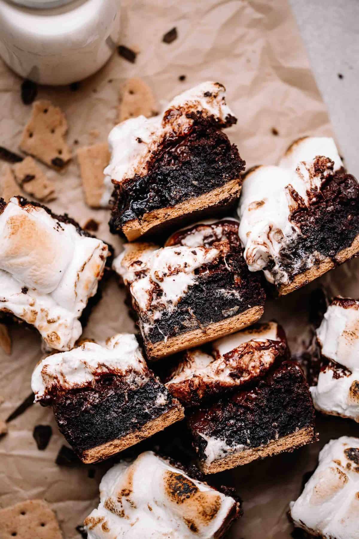 S'mores brownies on parchment paper with graham cracker pieces.