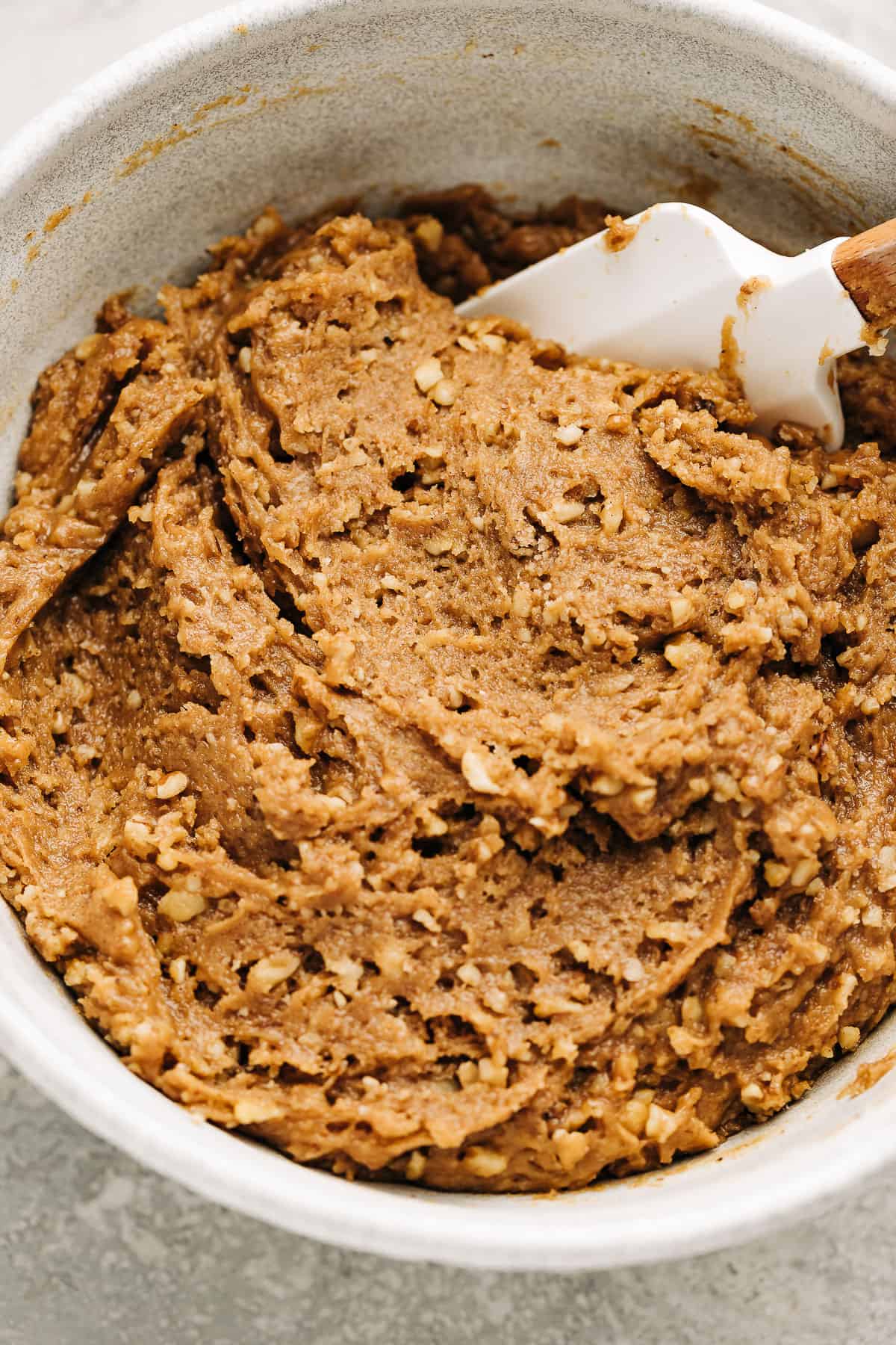 spice cookie batter in a mixing bowl with a rubber spatula.