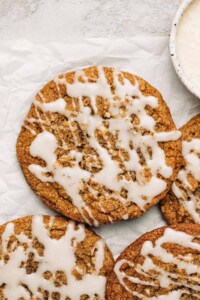 Spice cookie with glaze on parchment paper.