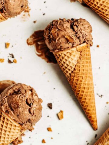 Scoops of chocolate peanut butter ice cream in cones.