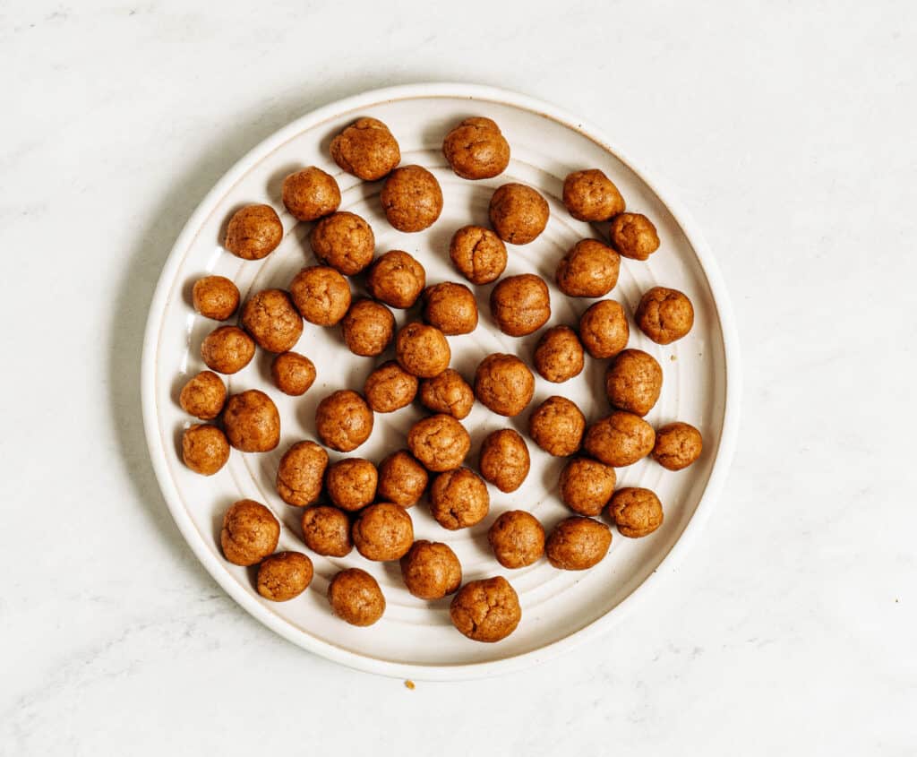 Roll cookie dough into marble sized balls and set aside.