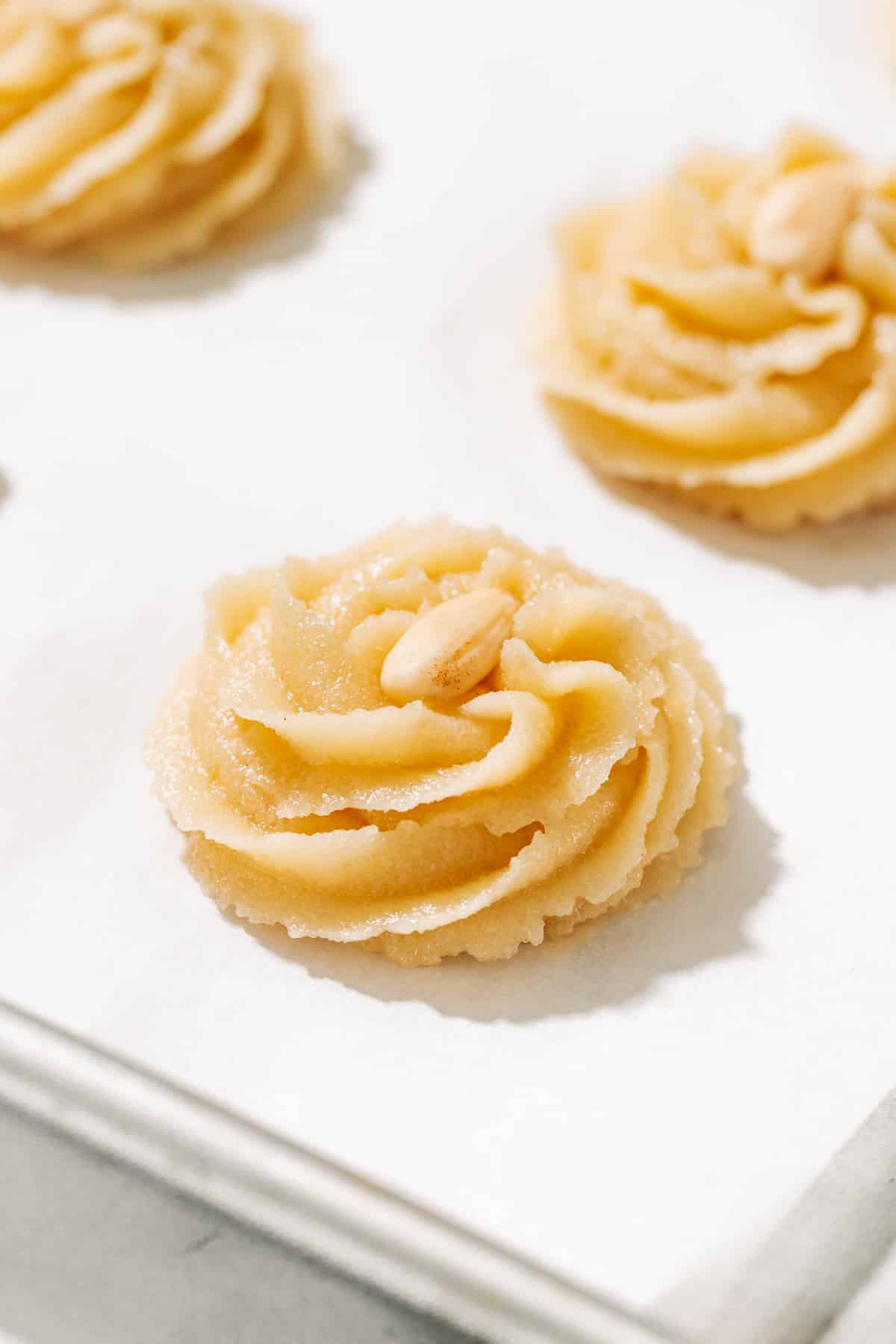 unbaked amygdalota on a baking tray.