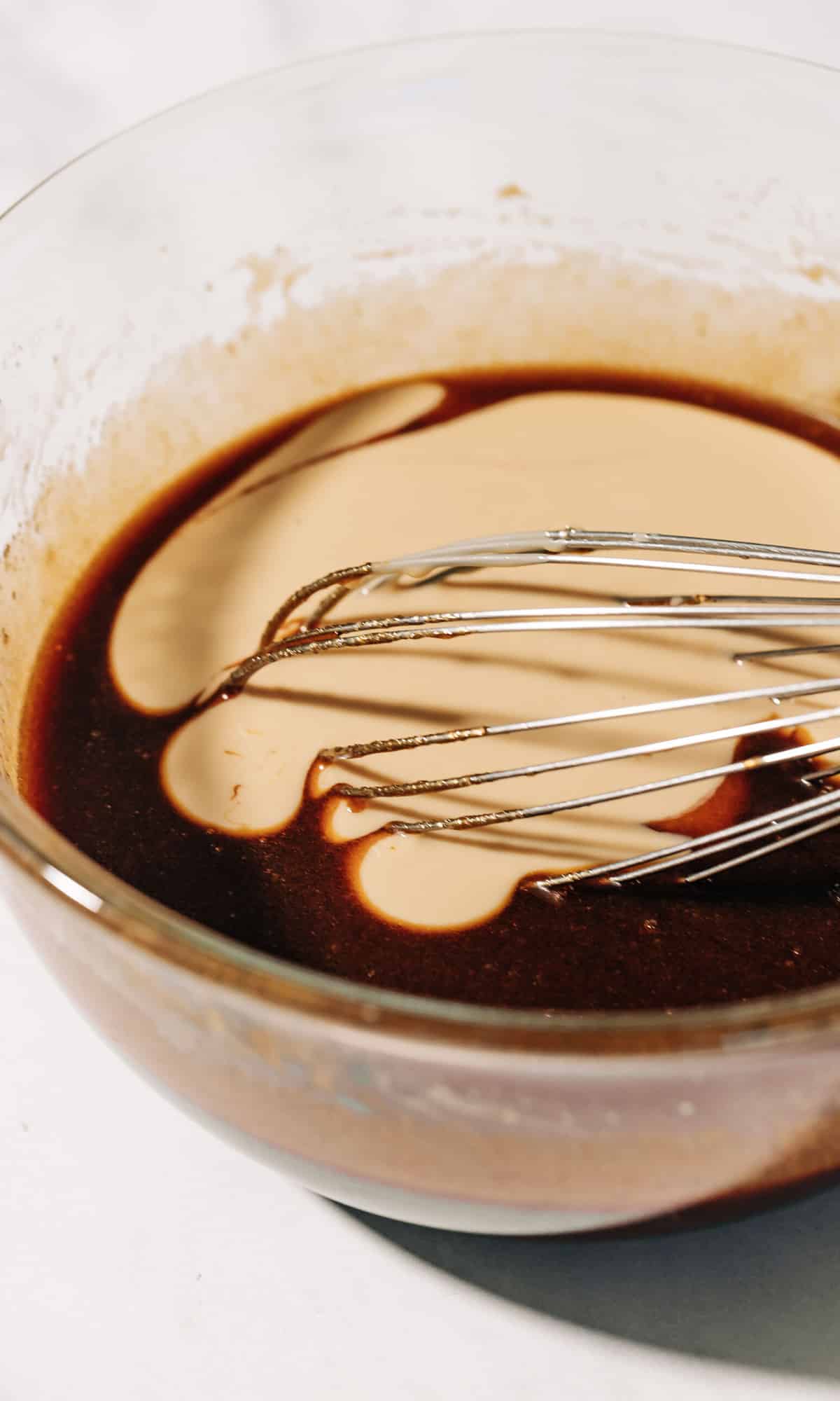 tahini with wet ingredients for cookies in a mixing bowl.