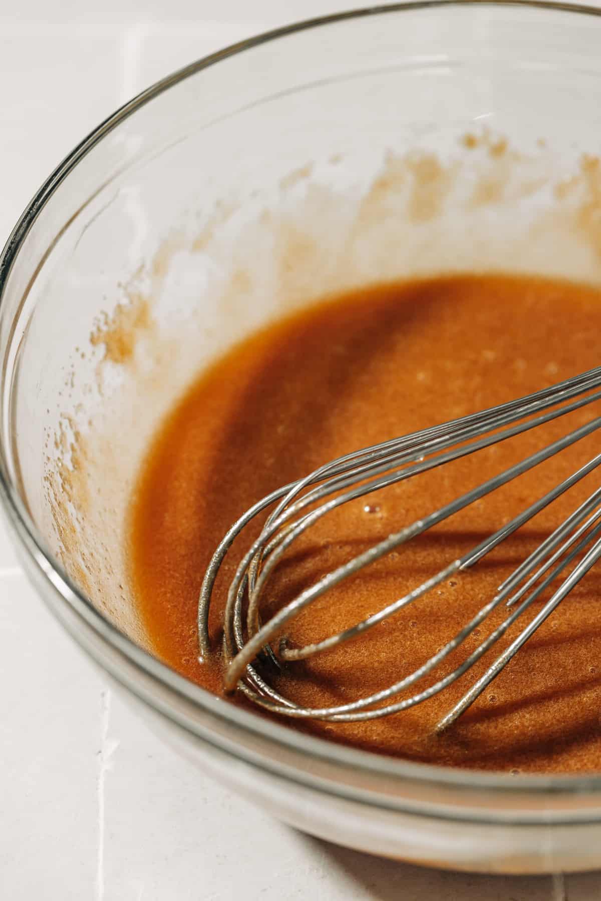 melted butter, brown sugar, an egg, and milk in a mixing bowl.