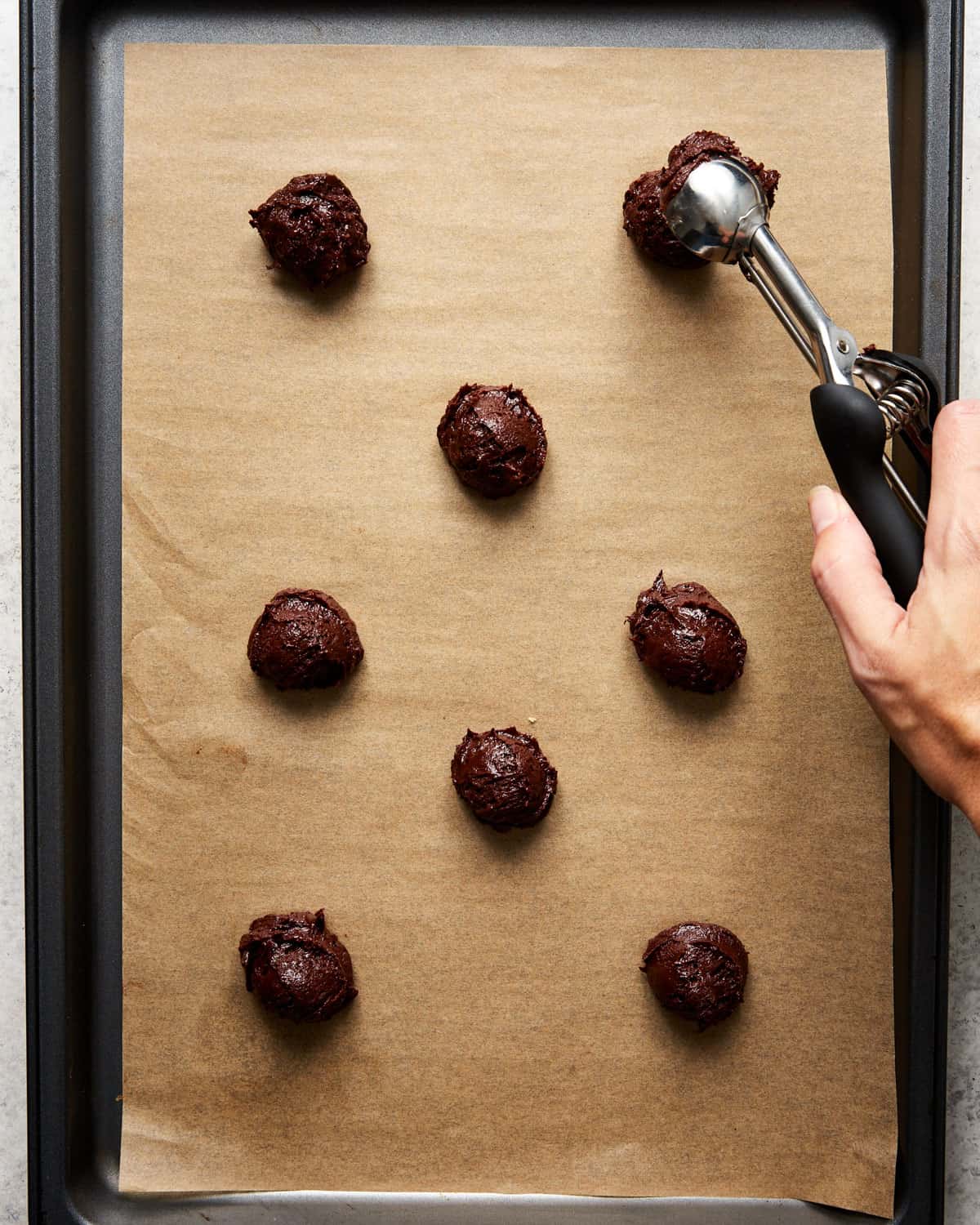 unbaked brownie cookies on a baking sheet.