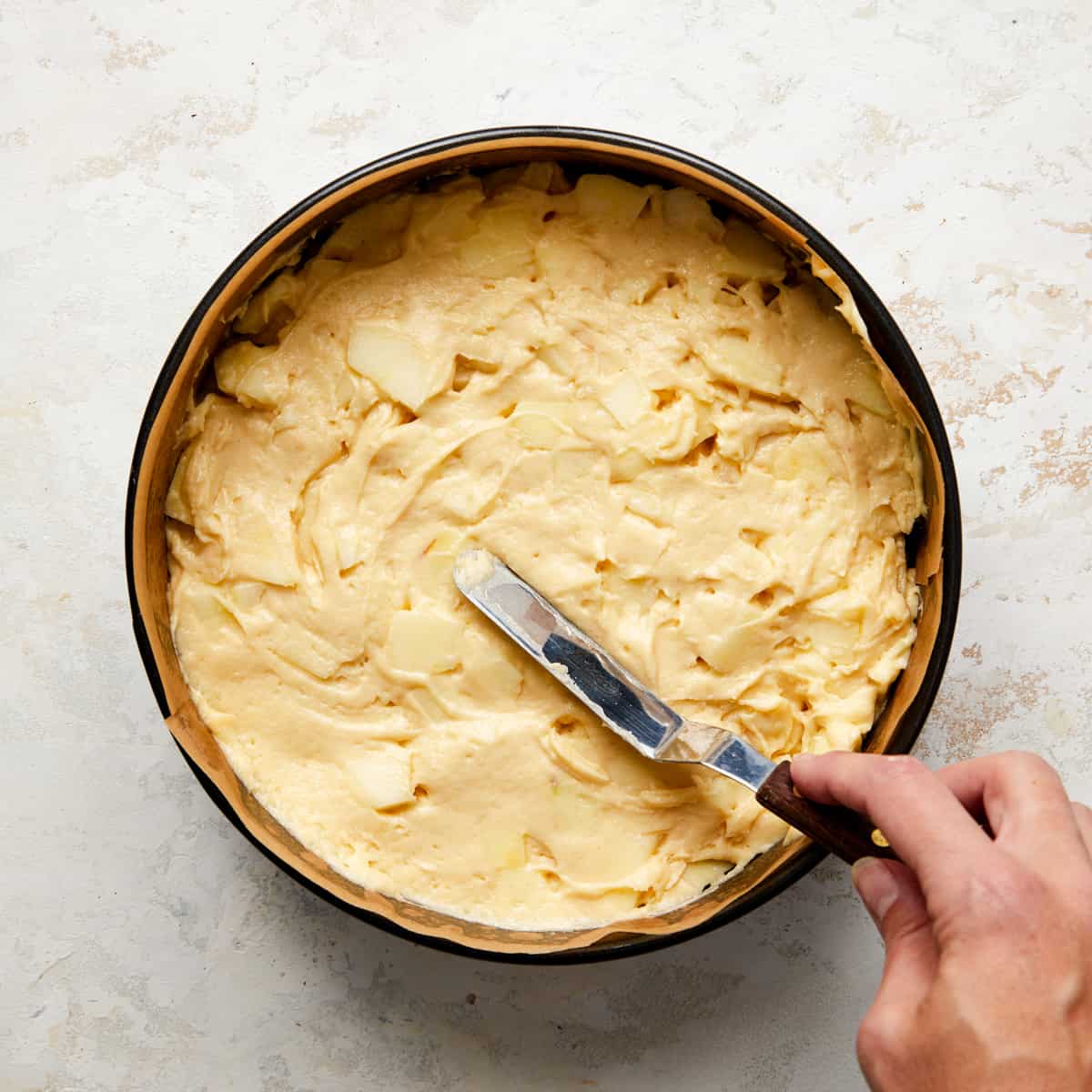 french apple cake batter in springform pan.