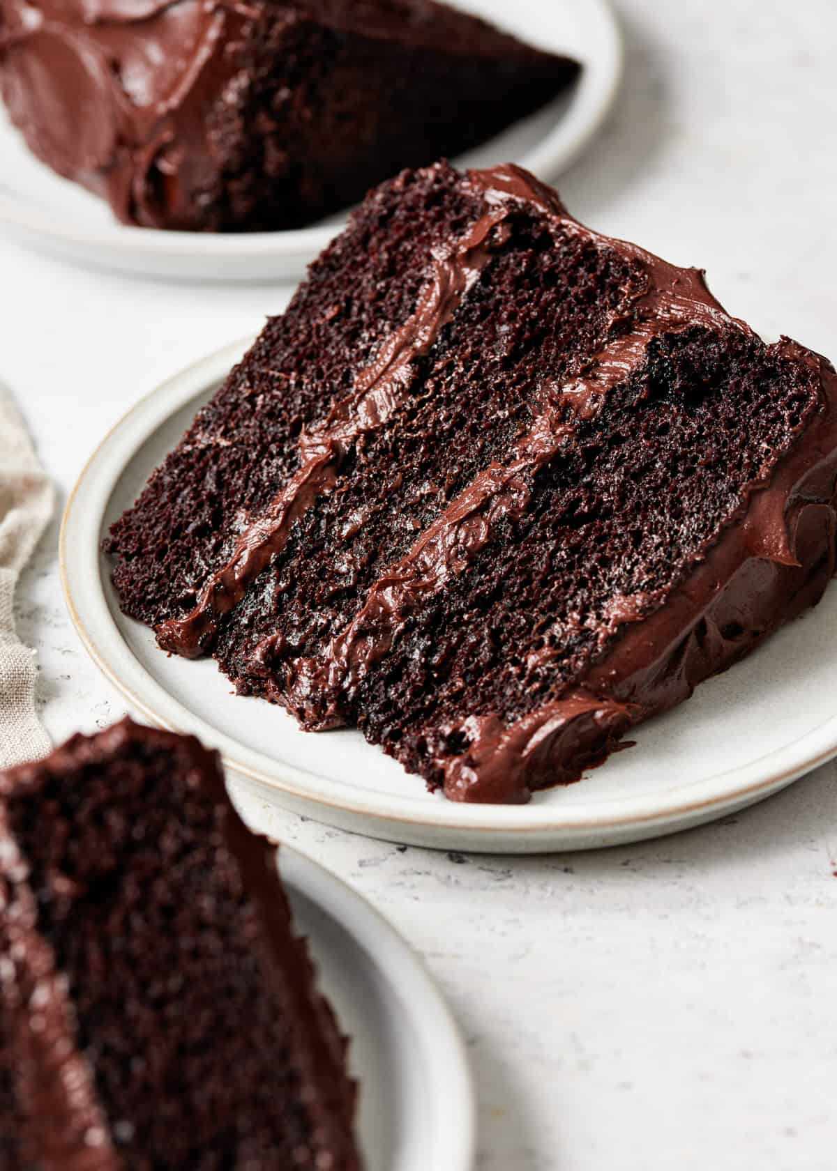 a slice of moist chocolate cake on a plate.