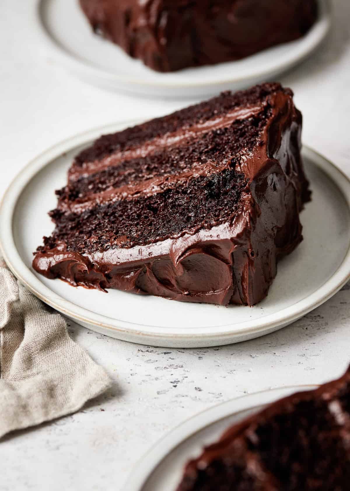 a slice of moist chocolate cake on a plate.