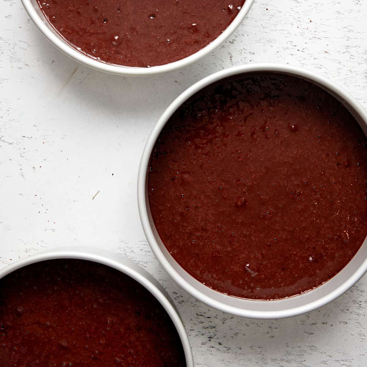 chocolate cake batter in pans.