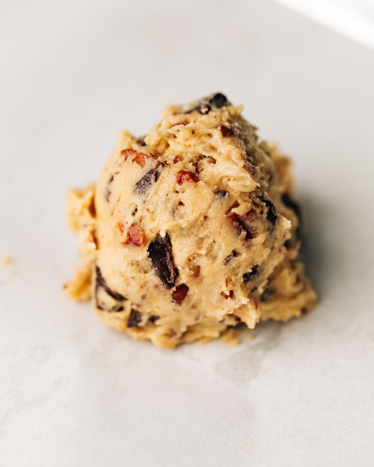 chocolate chip pecan cookie dough on a baking sheet.