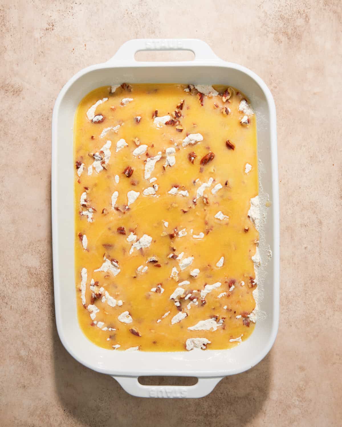 melted butter over pumpkin dump cake.