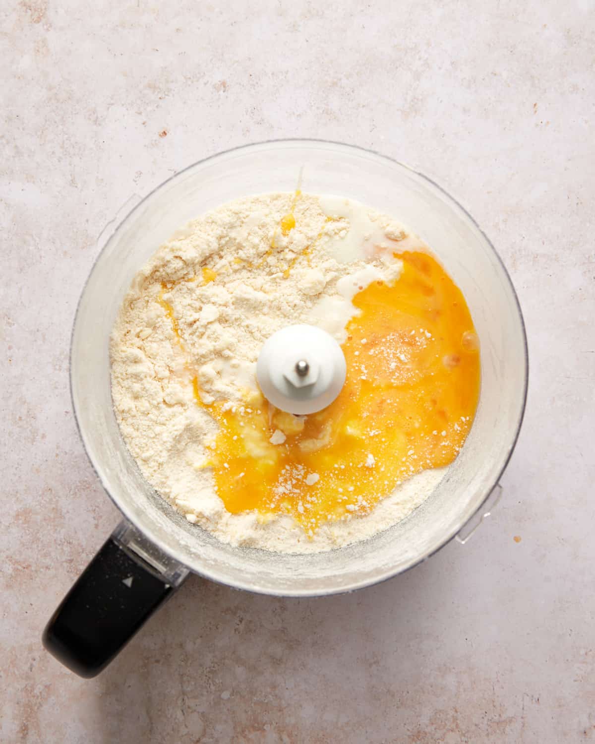 flour with beaten eggs in a food processor.